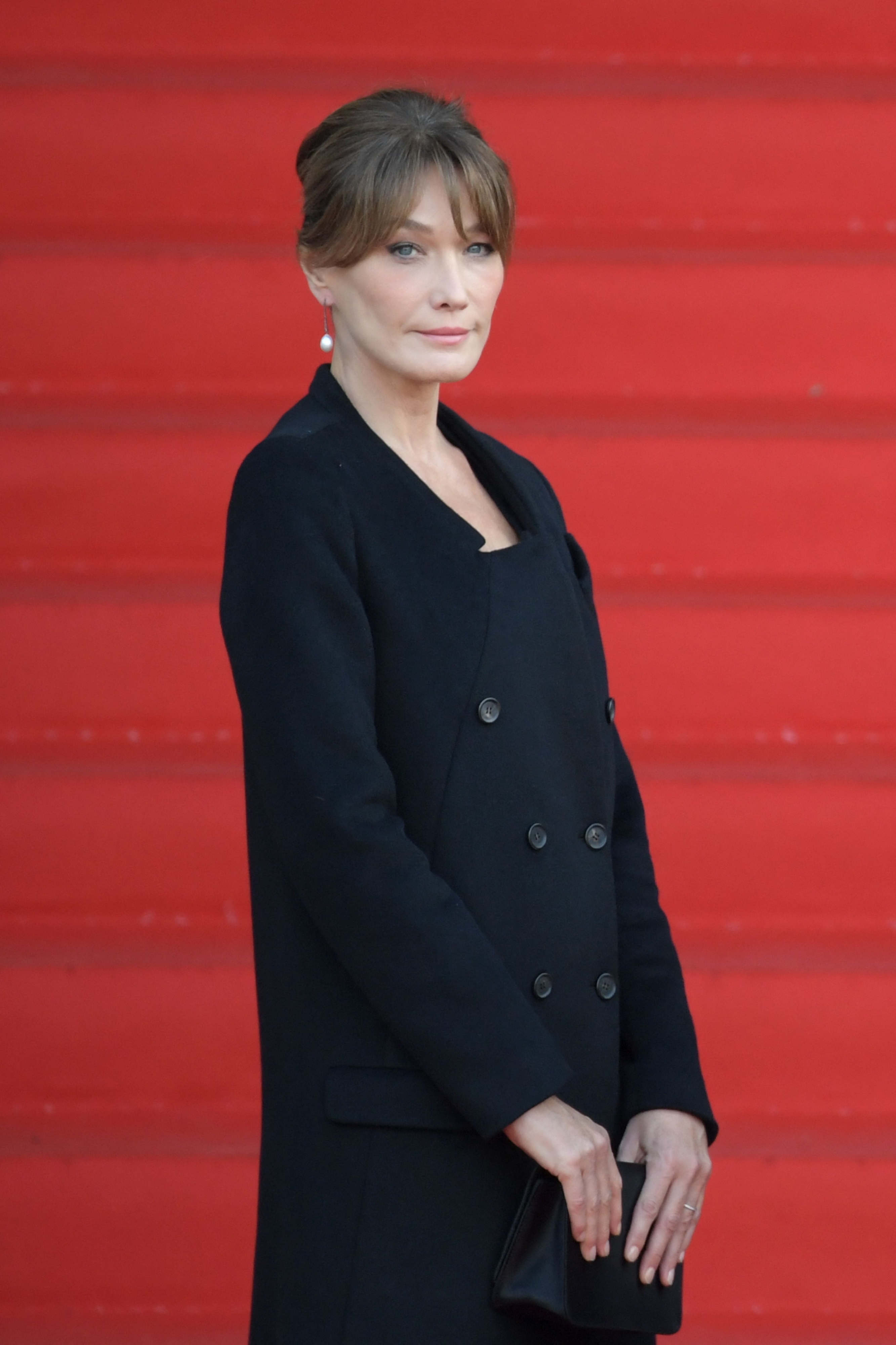 (FILES) French-Italian model and singer Carla Bruni-Sarkozy arrives to attend a church service for former French President Jacques Chirac at the Saint-Sulpice church in Paris on September 30, 2019. Bruni, who was questioned on June 2023 as a witness by financial investigators as part of judicial investigations into the retraction by intermediary Ziad Takieddine of accusations of the 2007 presidential campaign Libyan financing of her husband, Former French president Nicolas Sarkozy, will answer investigators on May 2, 2024 during a free hearing on the same case but as a suspect. (Photo by Eric Feferberg / AFP)