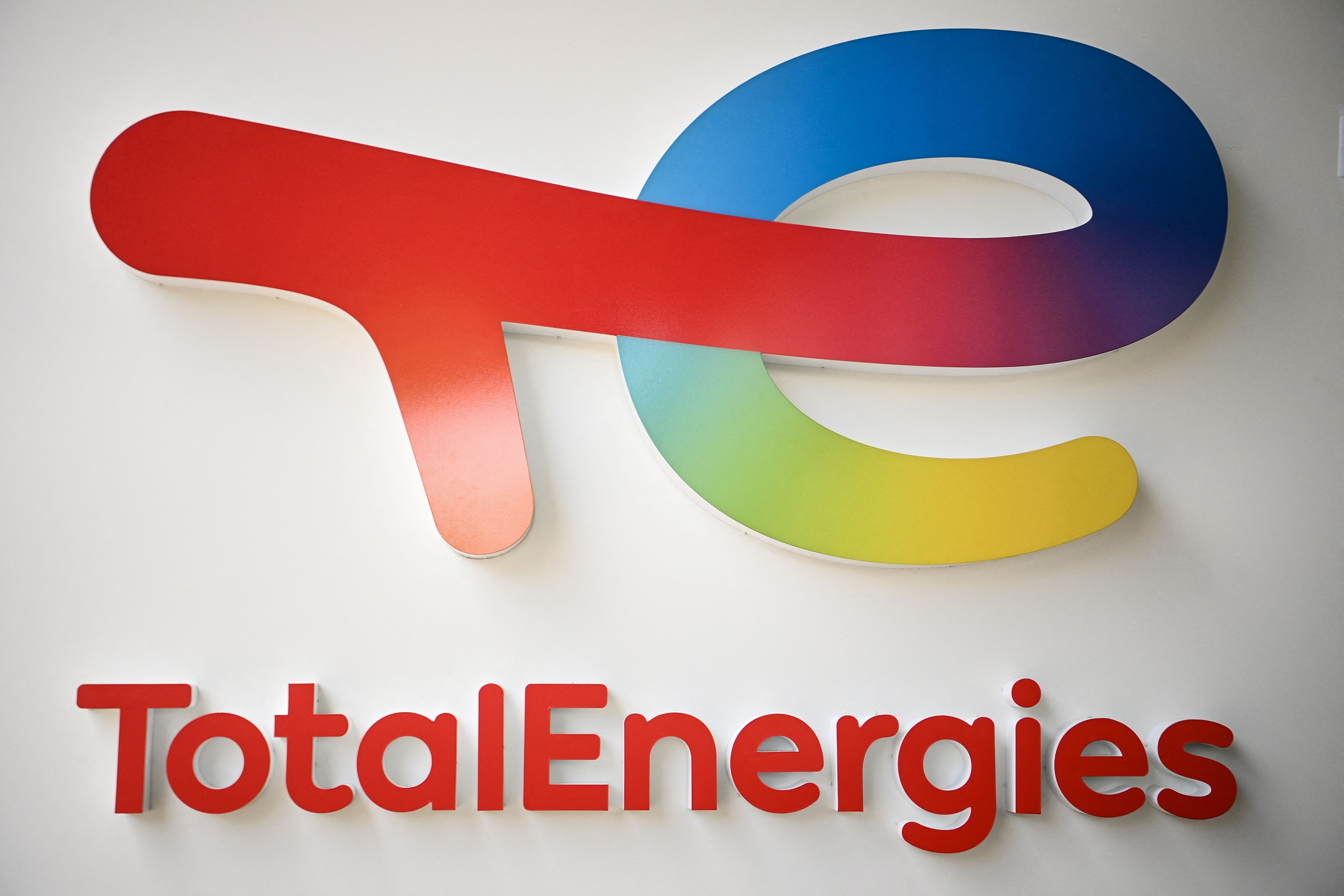 (FILES) This photograph taken on May 28, 2021 shows the new TotalEnergies logo during its unveling ceremony, at La Defense on the outskirts of Paris. France will "fight" to keep oil and gas giant TotalEnergies from shifting its main stock market listing to New York, French Finance Minister Bruno Le Maire said on May 2, 2024. (Photo by Christophe ARCHAMBAULT / AFP)