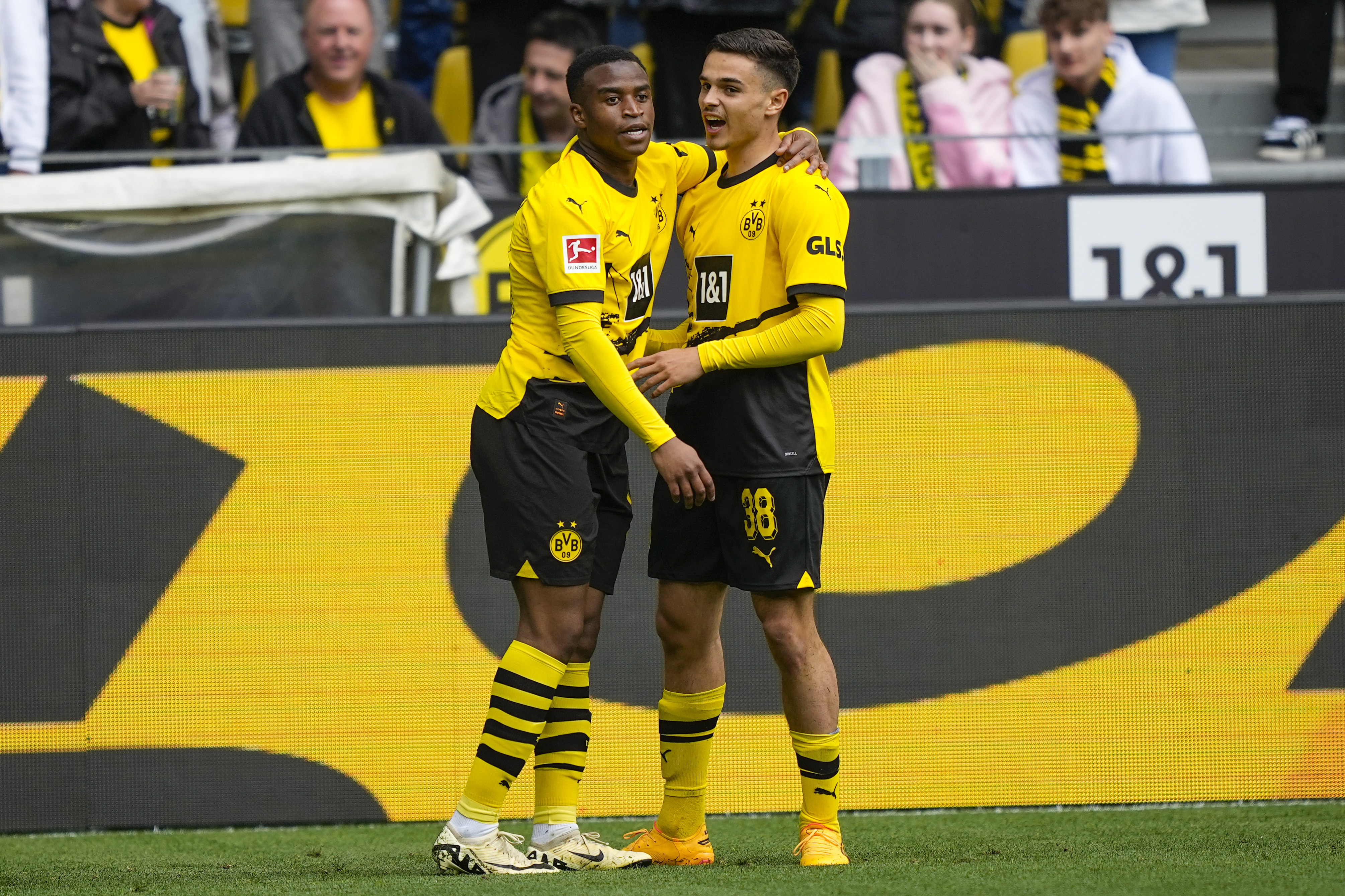 Dortmund's Youssoufa Moukoko, leftt, celebrates with his teammate Watjen Kjell-Arik after he scored his side's first goal during the German Bundesliga soccer match between Borussia Dortmund and Augsburg, in Dortmund, Saturday, May 4, 2024. (AP Photo/Martin Meissner)