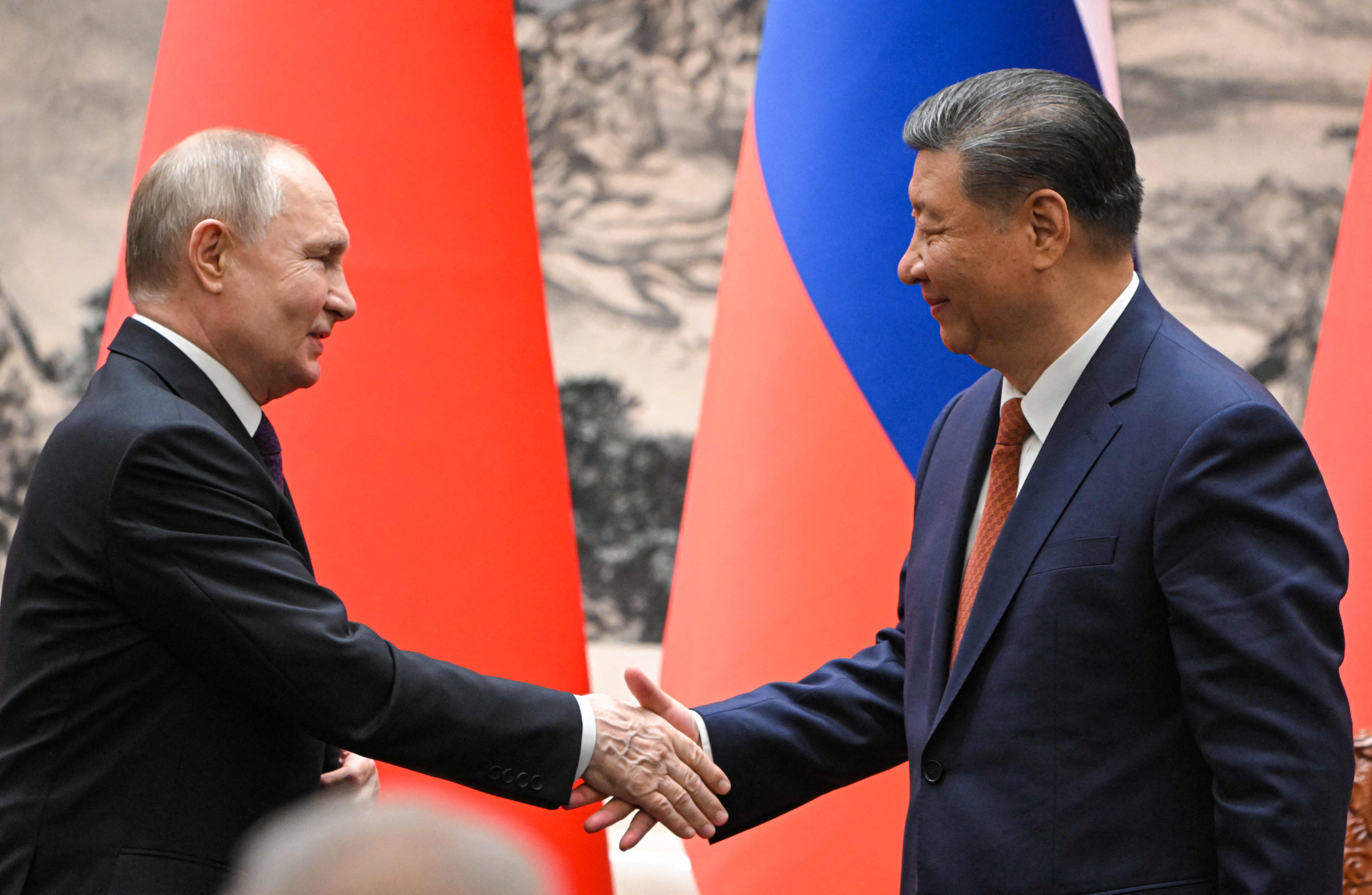 In this pool photograph distributed by the Russian state agency Sputnik, Russia's President Vladimir Putin and China's President Xi Jinping shake hands during a signing ceremony following their talks in Beijing on May 16, 2024. (Photo by Sergei GUNEYEV / POOL / AFP) / ** Editor's note : this image is distributed by Russian state owned agency Sputnik **