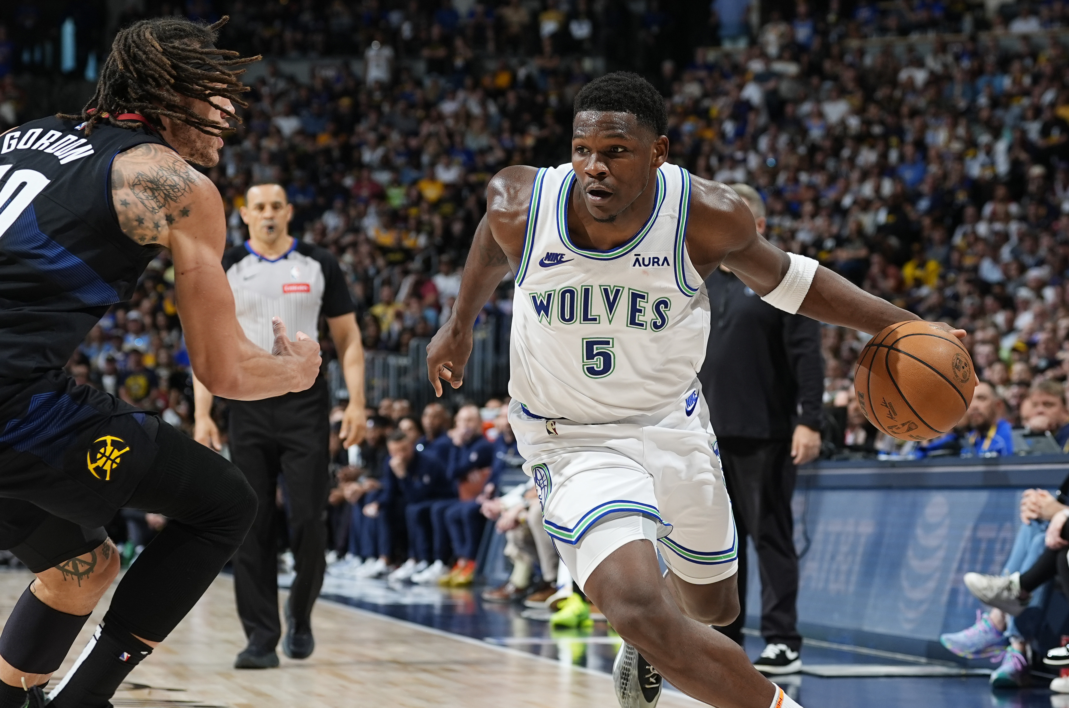Minnesota Timberwolves guard Anthony Edwards, right, drives past Denver Nuggets forward Aaron Gordon in the second half of Game 7 of an NBA second-round playoff series Sunday, May 19, 2024, in Denver. (AP Photo/David Zalubowski)