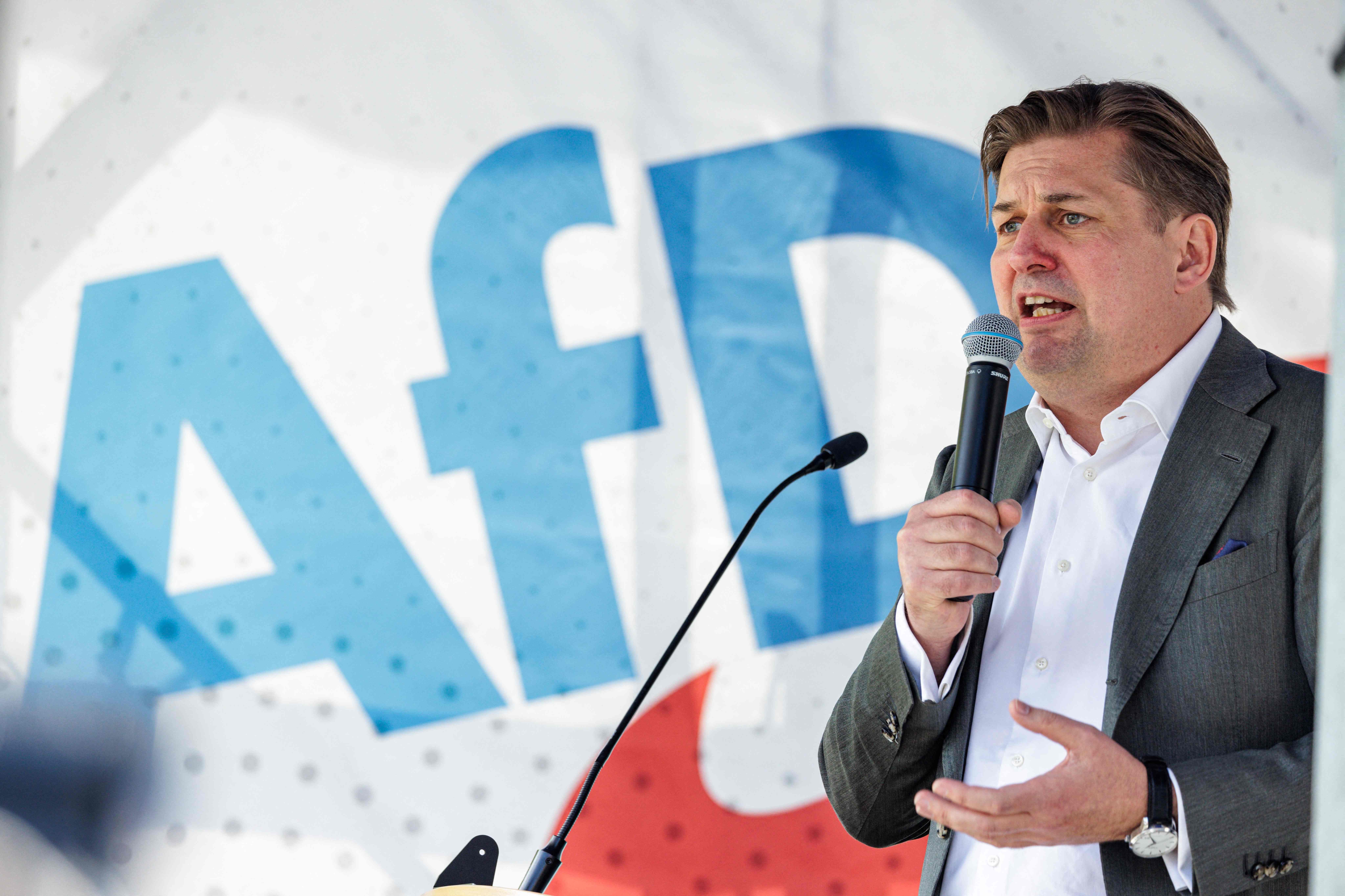(FILES) Top candidate of Germany's far-right Alternative for Germany (AfD) party for the European election Maximilian Krah speaks during a campaign event for the upcoming European elections in Dresden, eastern Germany on May 1, 2024. Germany's AfD on May 22, 2024 banned its scandal-hit lead candidate from EU election events, a spokesman of the party said. Maximilian Krah, who is the AfD's top candidate for June's EU elections, is at the centre of a deepening crisis after one of his aides in the European Parliament was arrested on suspicion of spying for China. German prosecutors have also launched a preliminary investigation against Krah himself over reports of suspicious payments received from China and Russia. (Photo by JENS SCHLUETER / AFP)