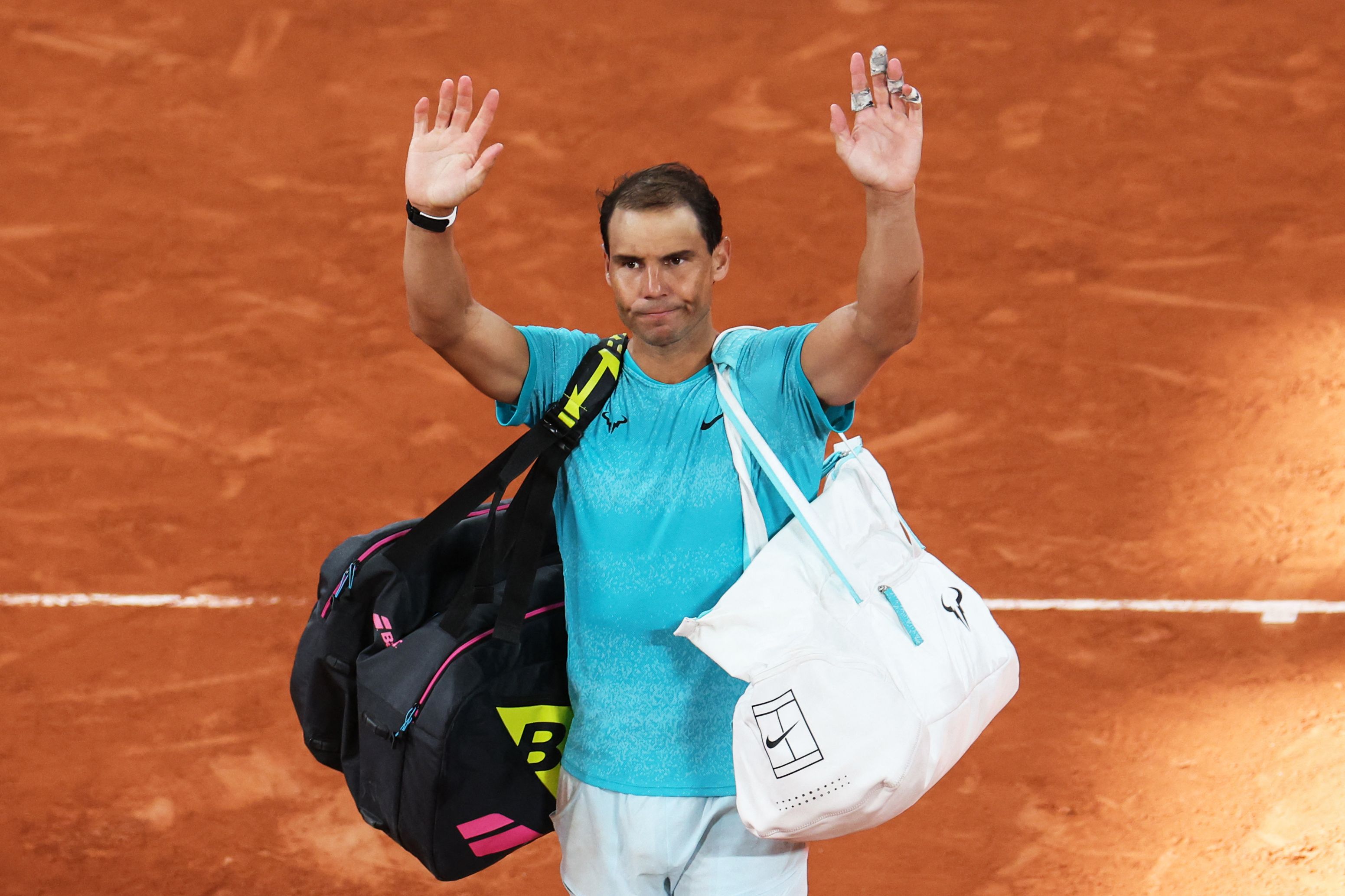 Spain's Rafael Nadal gestures to the public as he leaves the court after losing against Germany's Alexander Zverev in their men's singles match on Court Philippe-Chatrier on day two of The French Open tennis tournament at The Roland Garros Complex in Paris on May 27, 2024. (Photo by Alain JOCARD / AFP)