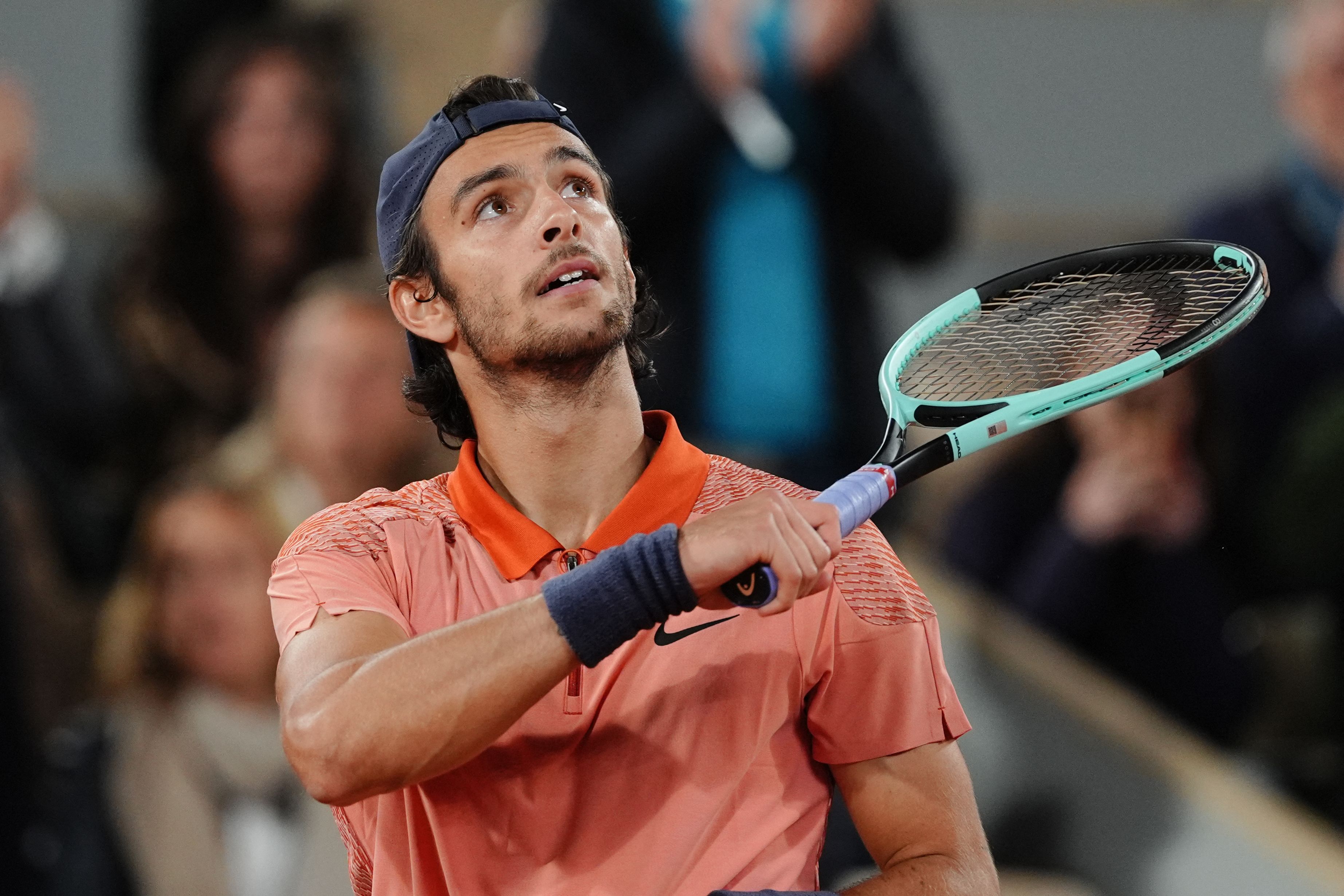 Italy's Lorenzo Musetti celebrates after winning against France's Gael Monfils at the end of their men's singles match on Court Philippe-Chatrier on day five of the French Open tennis tournament at the Roland Garros Complex in Paris on May 30, 2024. (Photo by Dimitar DILKOFF / AFP)