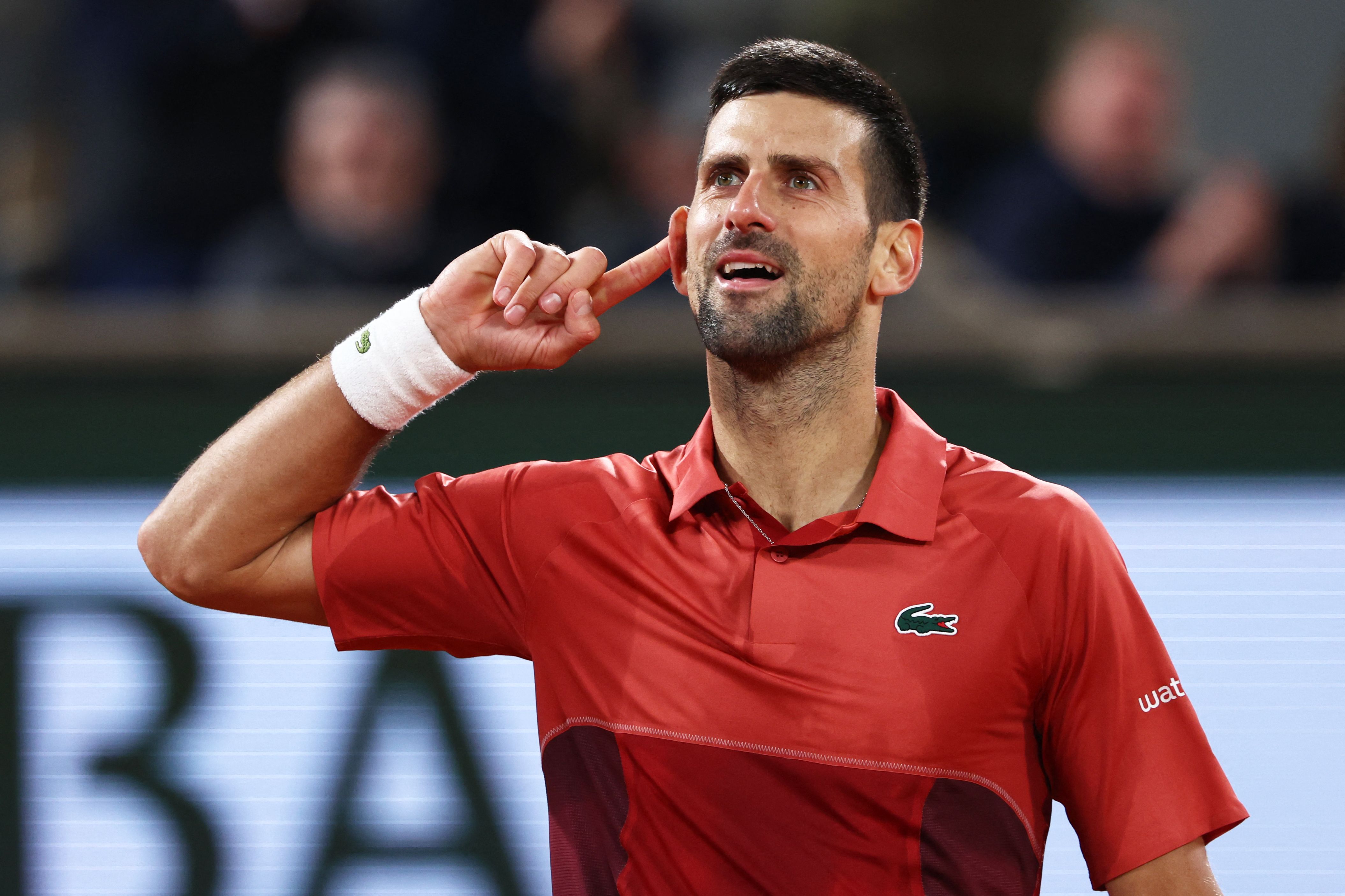 Serbia's Novak Djokovic celebrates after a point as he plays against Italy's Lorenzo Musetti during their men's singles match on Court Philippe-Chatrier on day seven of the French Open tennis tournament at the Roland Garros Complex in Paris on June 2, 2024. (Photo by EMMANUEL DUNAND / AFP)