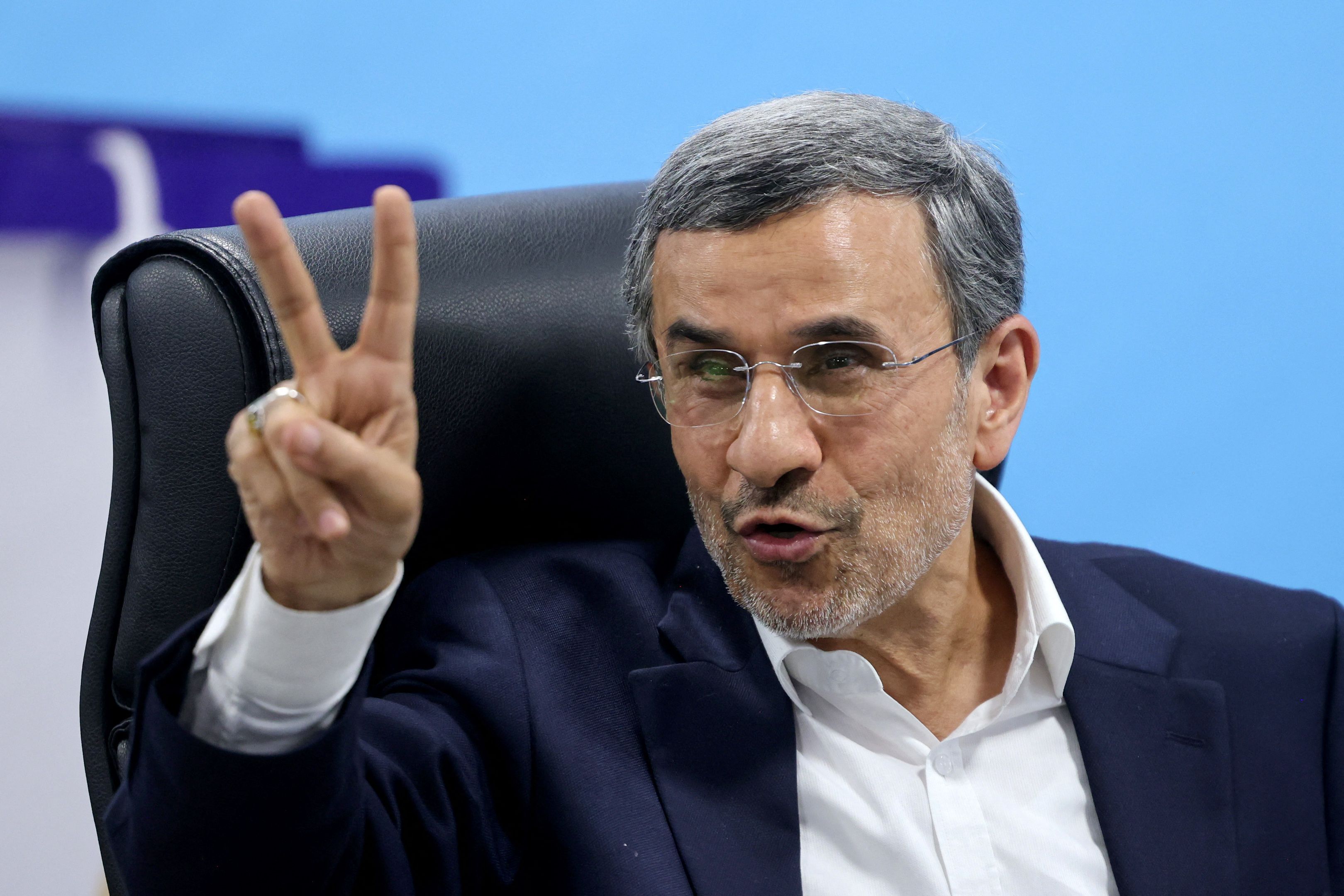 TOPSHOT - Former Iranian president Mahmoud Ahmadinejad flashes the V-sign for victory after registering his candidacy for Iran's upcoming presidential election in Tehran on June 2, 2024. Iran's hardline former president, 67, held the post for two consecutive terms from 2005 to 2013 with his tenure marked by incendiary remarks on Israel and standoffs with the West especially over Iran's nuclear programme. Like all presidential hopefuls, his bid is pending the approval of the Guardian Council, a conservative-dominated 12-strong body of jurists that vets all candidates for public office. (Photo by ATTA KENARE / AFP)
