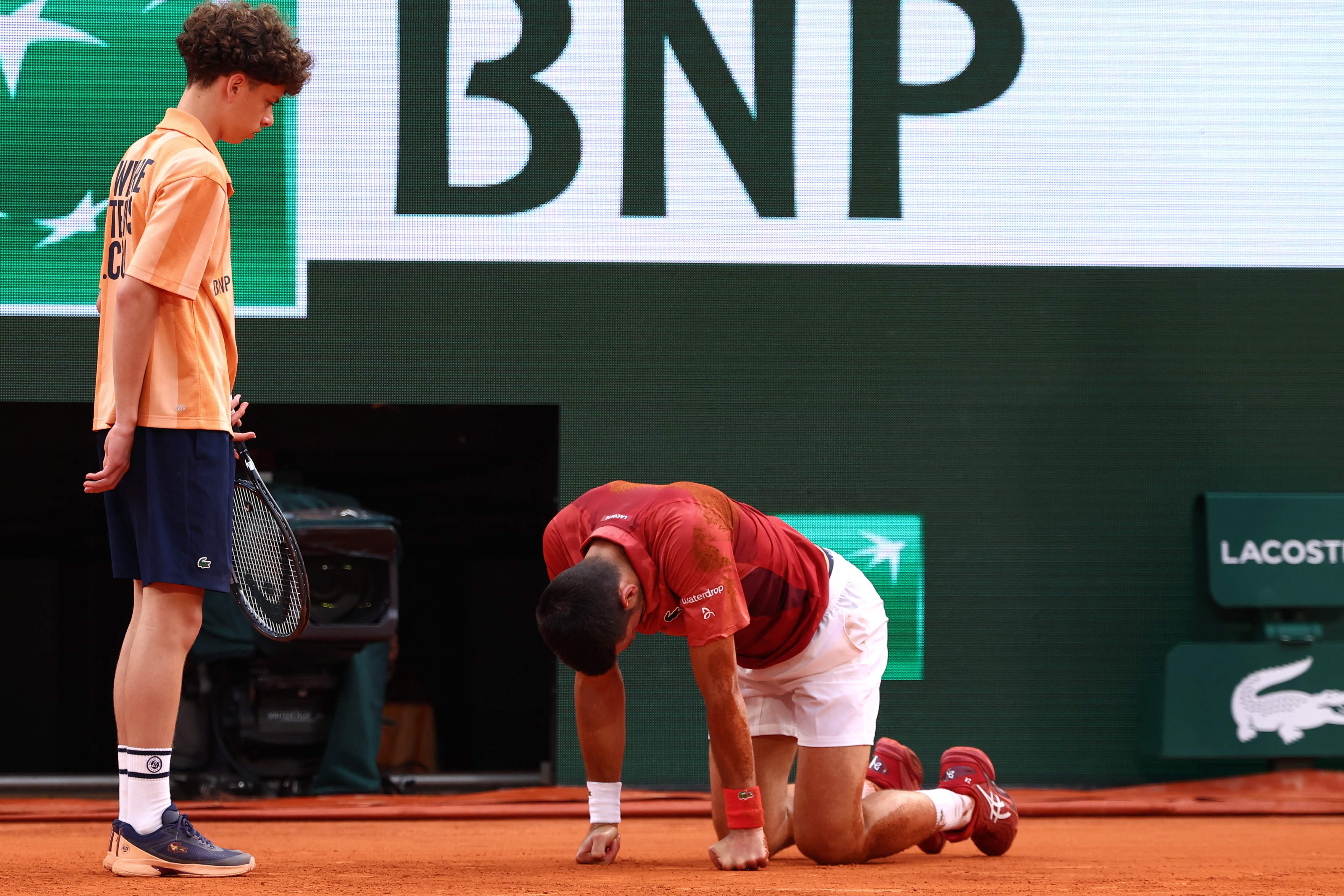 Serbia's Novak Djokovic reacts after falling on the court during his men's singles round of sixteen match against Argentina's Francisco Cerundolo on Court Philippe-Chatrier on day nine of the French Open tennis tournament at the Roland Garros Complex in Paris on June 3, 2024. (Photo by Emmanuel Dunand / AFP)
