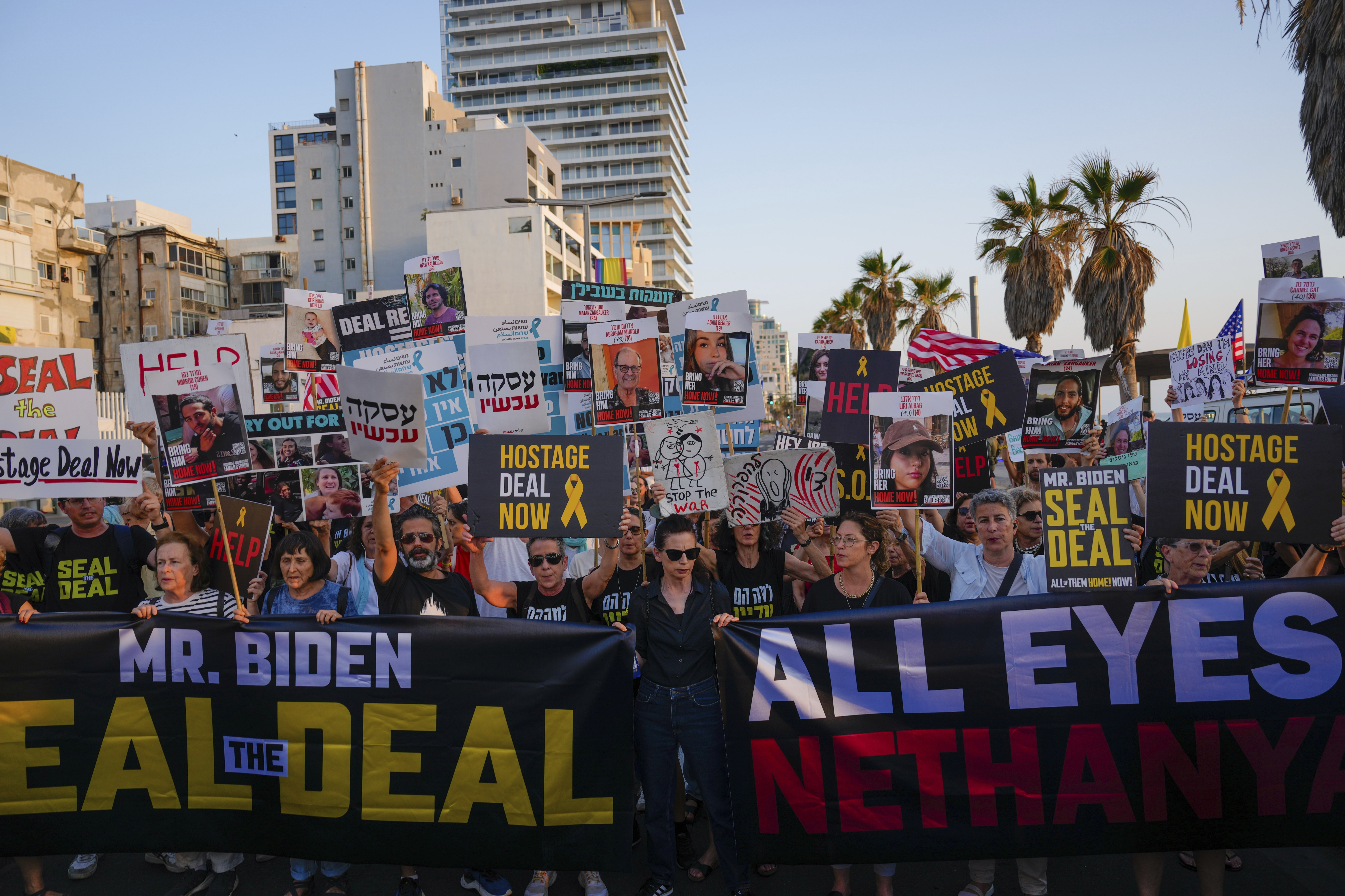 Demonstrators wave signs during a protest calling for the release of the hostages from Hamas captivity in the Gaza Strip, outside of the U.S. Embassy Branch Office in Tel Aviv, Israel, Monday, June 3, 2024. (AP Photo/Ariel Schalit)