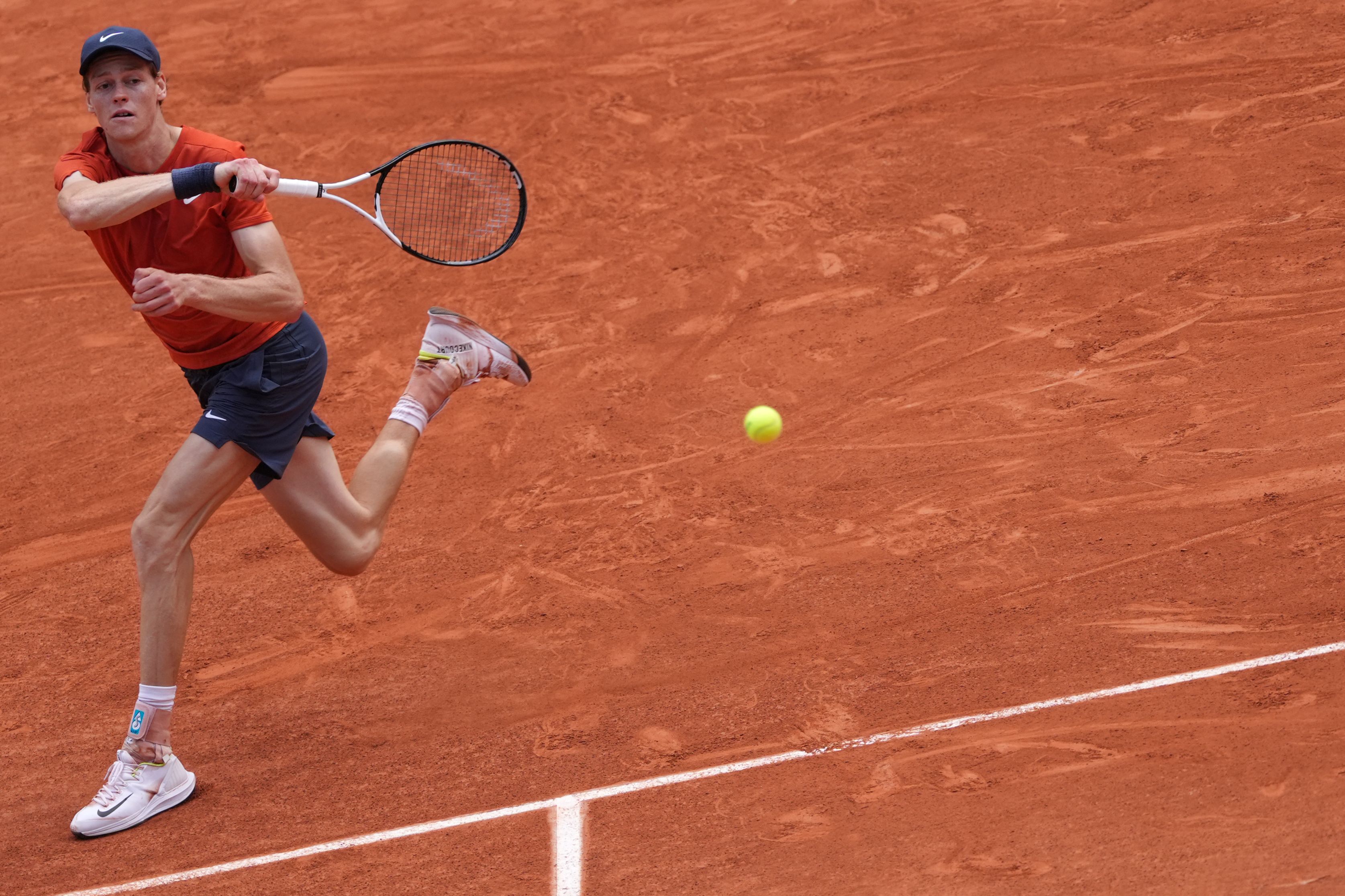Italy's Jannik Sinner plays a forehand return to Bulgaria's Grigor Dimitrov during their men's singles quarter final match on Court Philippe-Chatrier on day ten of the French Open tennis tournament at the Roland Garros Complex in Paris on June 4, 2024. (Photo by Dimitar DILKOFF / AFP)