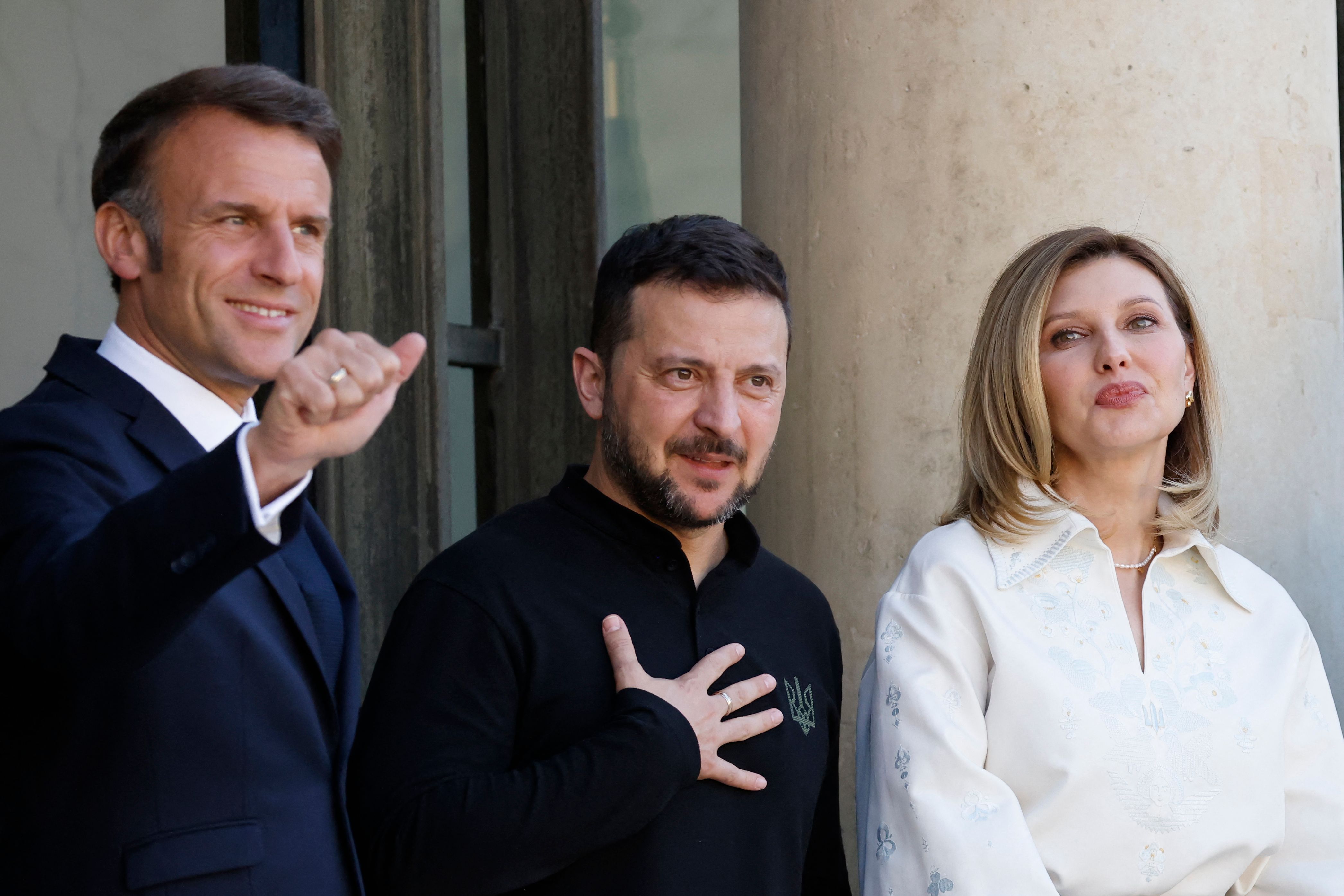 France's President Emmanuel Macron (L) greets Ukraine's President Volodymyr Zelensky (C) and his wife Olena Zelenska (R) prioer to their bilateral meeting at the Elysee Palace in Paris on June 7, 2024. (Photo by Ludovic MARIN / AFP)