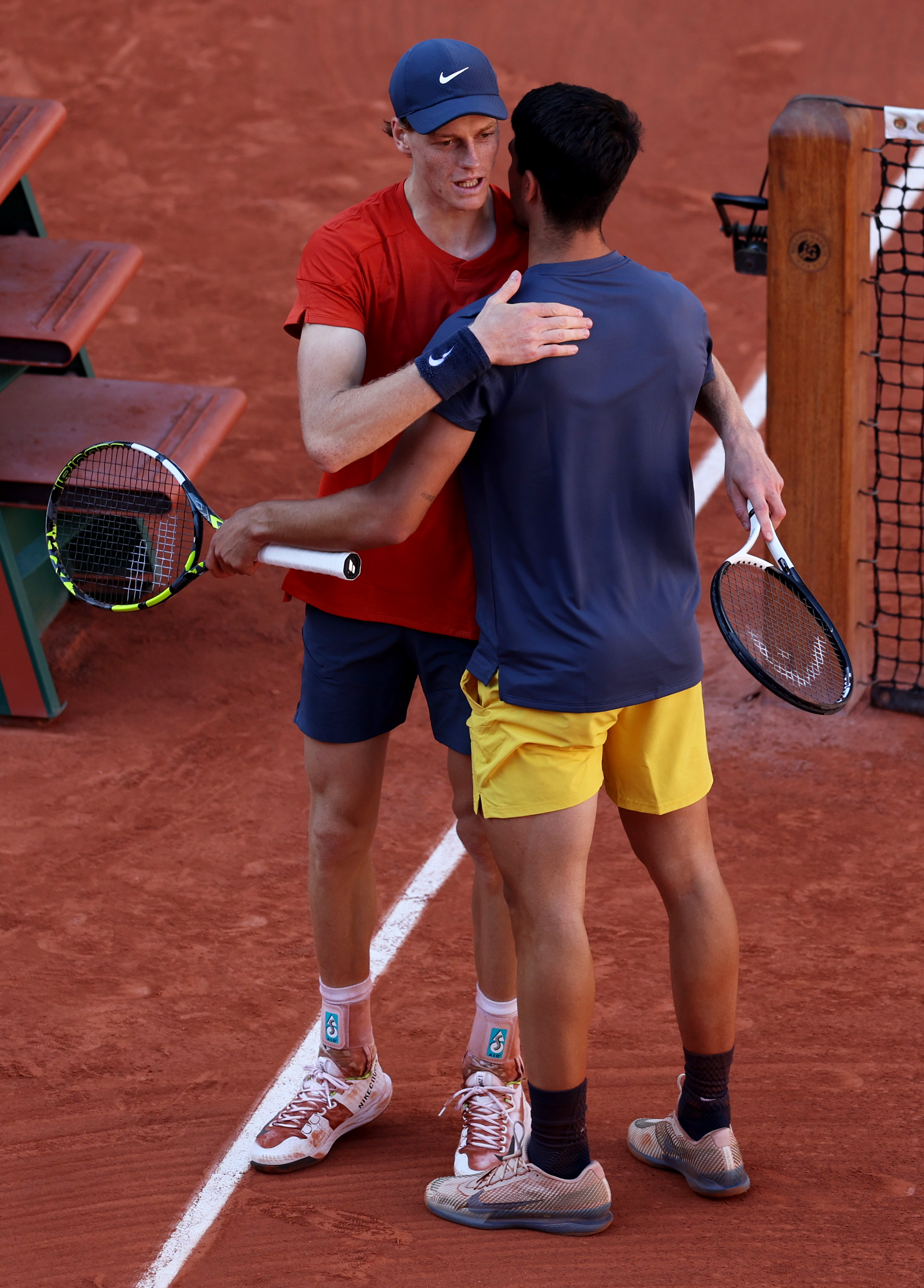 PARIS, FRANCE - JUNE 07:  Carlos Alcaraz of Spain embraces at the net after his five set victor against Jannik Sinner of Italy during the Men's Singles Semi-Final match on Day Thirteen of the 2024 French Open at Roland Garros on June 07, 2024 in Paris, France. (Photo by Clive Brunskill/Getty Images)