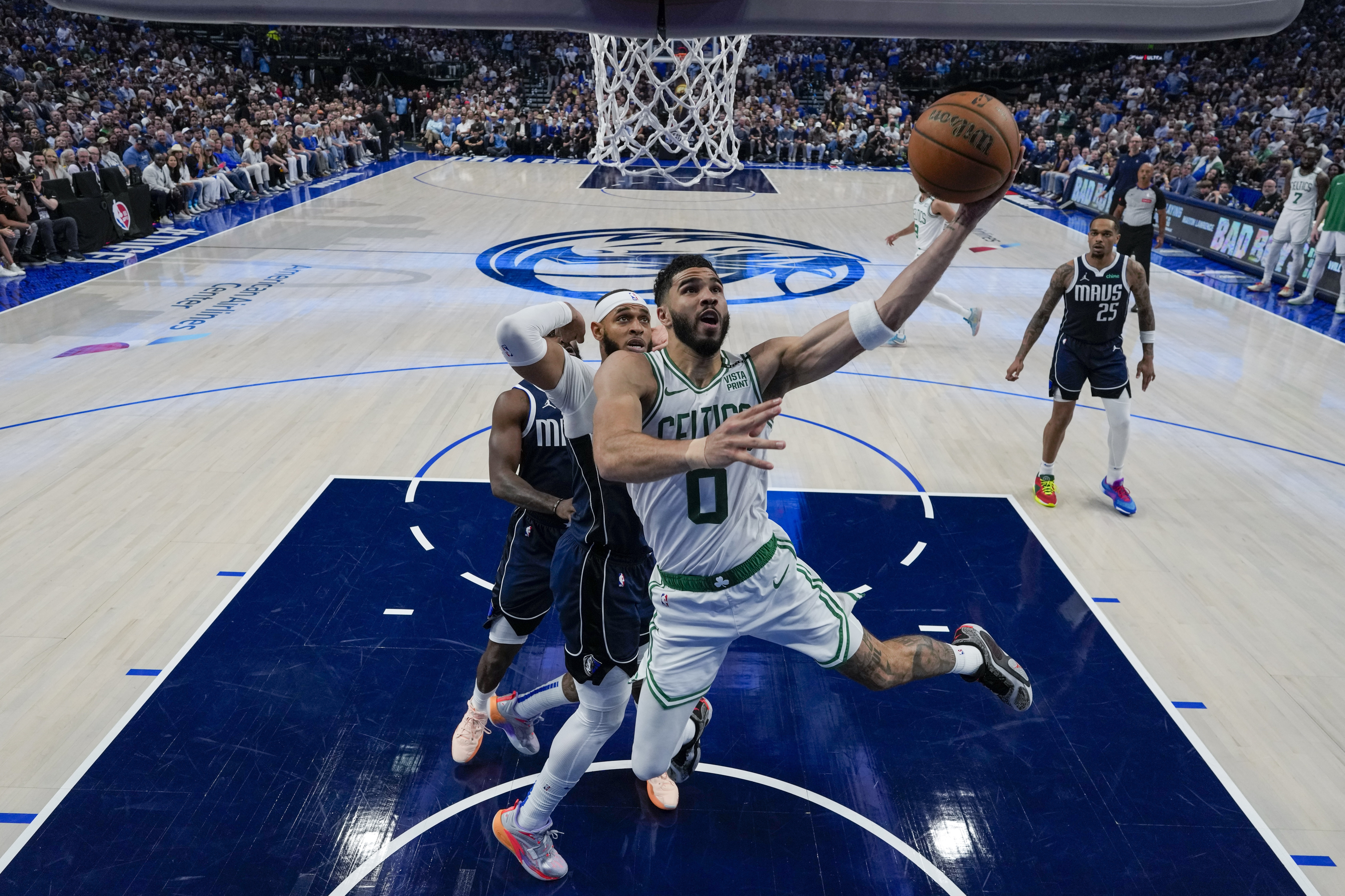 Boston Celtics forward Jayson Tatum (0) goes up for a basket in front of Dallas Mavericks forward P.J. Washington during the first half in Game 3 of the NBA basketball finals, Wednesday, June 12, 2024, in Dallas. The Celtics won 106-99. (AP Photo/Julio Cortez, Pool)