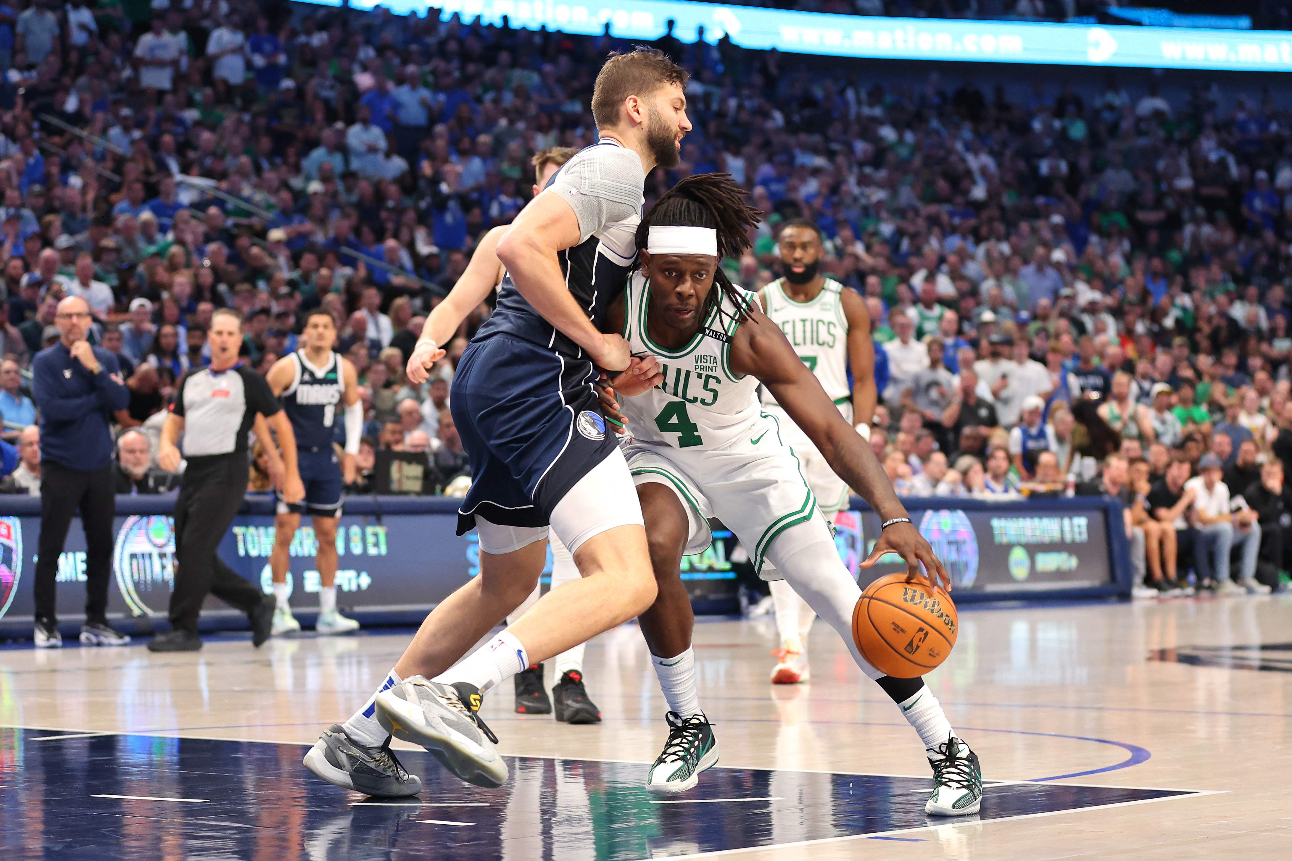 DALLAS, TEXAS - JUNE 14: Jrue Holiday #4 of the Boston Celtics drives to the basket against Maxi Kleber #42 of the Dallas Mavericks during the third quarter in Game Four of the 2024 NBA Finals at American Airlines Center on June 14, 2024 in Dallas, Texas. NOTE TO USER: User expressly acknowledges and agrees that, by downloading and or using this photograph, User is consenting to the terms and conditions of the Getty Images License Agreement.   Stacy Revere/Getty Images/AFP (Photo by Stacy Revere / GETTY IMAGES NORTH AMERICA / Getty Images via AFP)