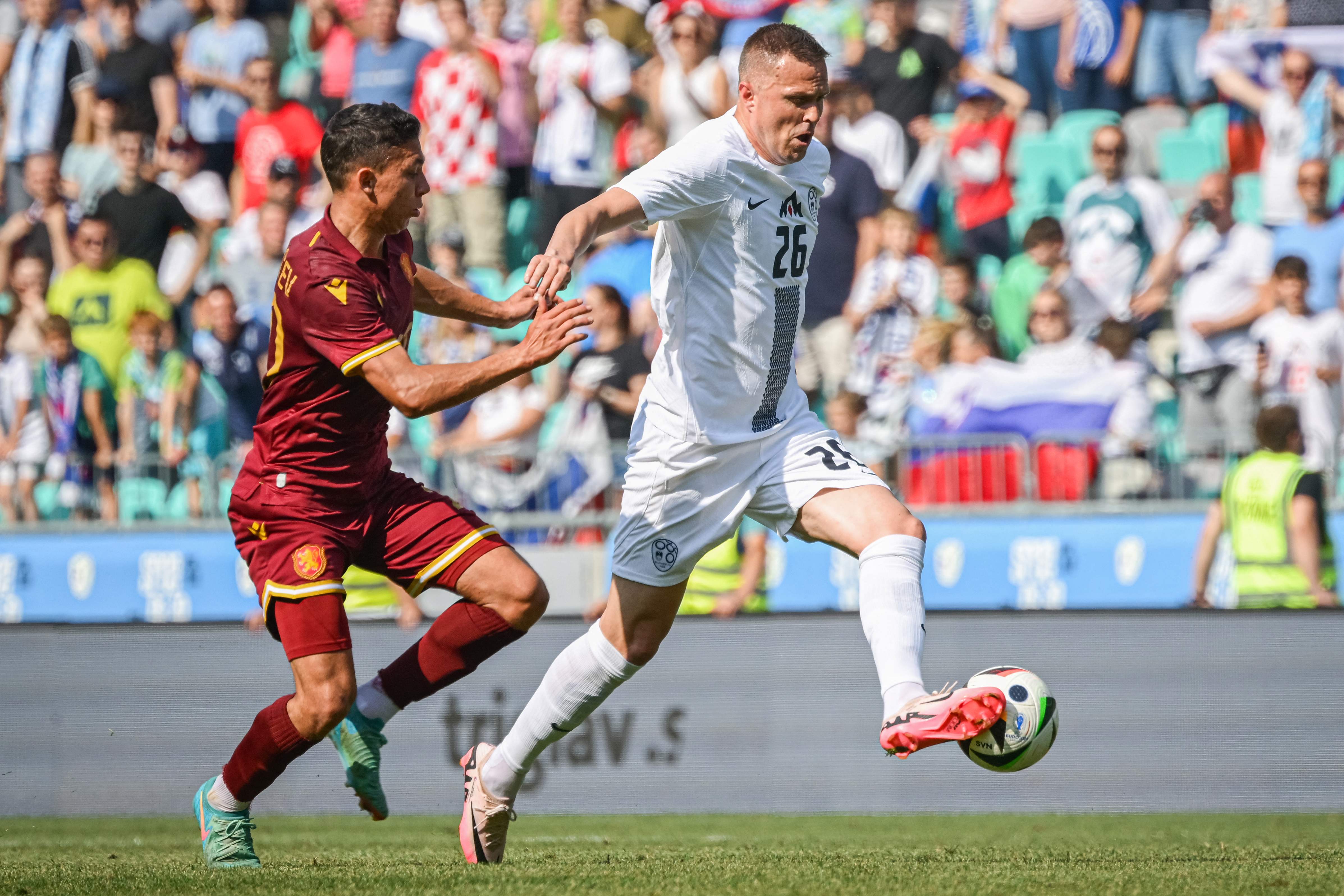 Slovenia's forward #26 Josip Ilicic (R) fights for the ball with Bulgaria's midfielder #20 Filip Krastev (L) during the International friendly football match between Slovenia and Bulgaria at the Stadium Stozice, in Ljubljana, on June 8, 2024. (Photo by Jure Makovec / AFP)