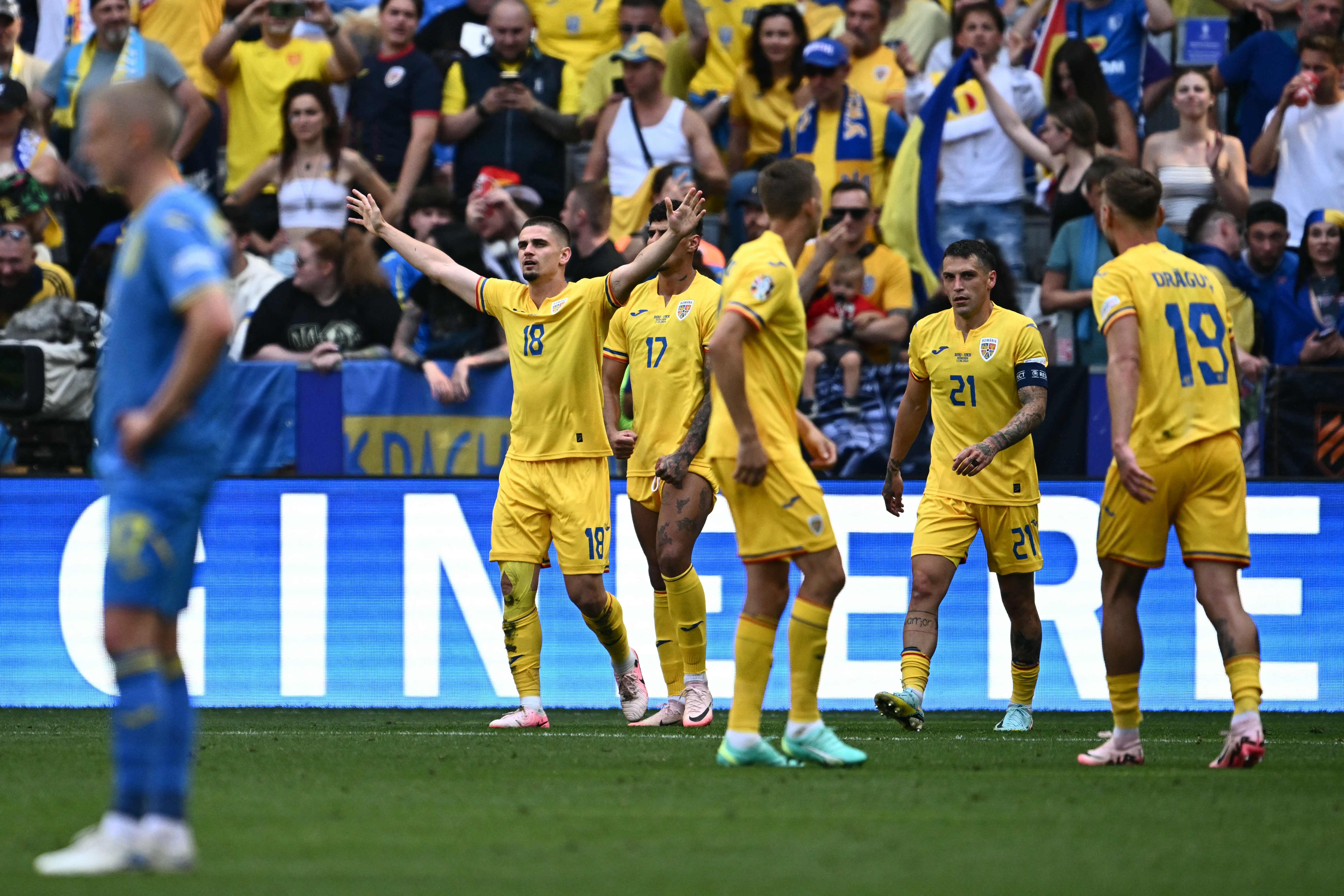 Romania's midfielder #18 Razvan Marin celebrates scoring his team's second goal with his team mates during the UEFA Euro 2024 Group E football match between Romania and Ukraine at the Munich Football Arena in Munich on June 17, 2024. (Photo by Fabrice COFFRINI / AFP)