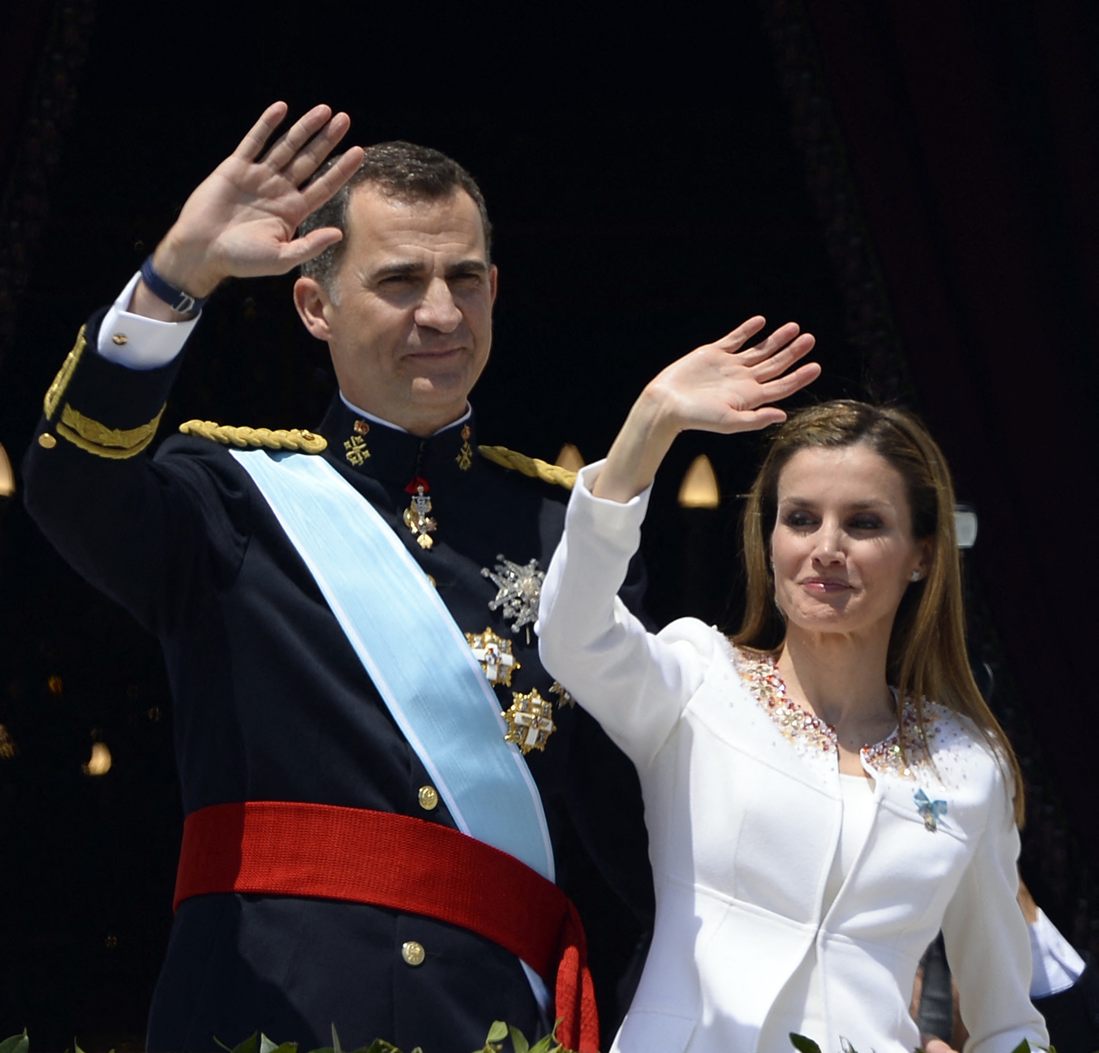 (FILES) Spain's King Felipe VI and Spain's Queen Letizia wave from the balcony of the Palacio de Oriente or Royal Palace in Madrid on June 19, 2014 following a swearing in ceremony of Spain's new King before both houses of parliament. Spain marks the 10th anniversary of King Felipe VI reign on June 19, 2024. Spain's King Felipe VI began his reign on June 19, 2014 after Spanish King Juan Carlos announced his abdication, ending a 39-year reign that guided Spain from dictatorship to democracy but was later battered by royal scandals. (Photo by GERARD JULIEN / AFP)