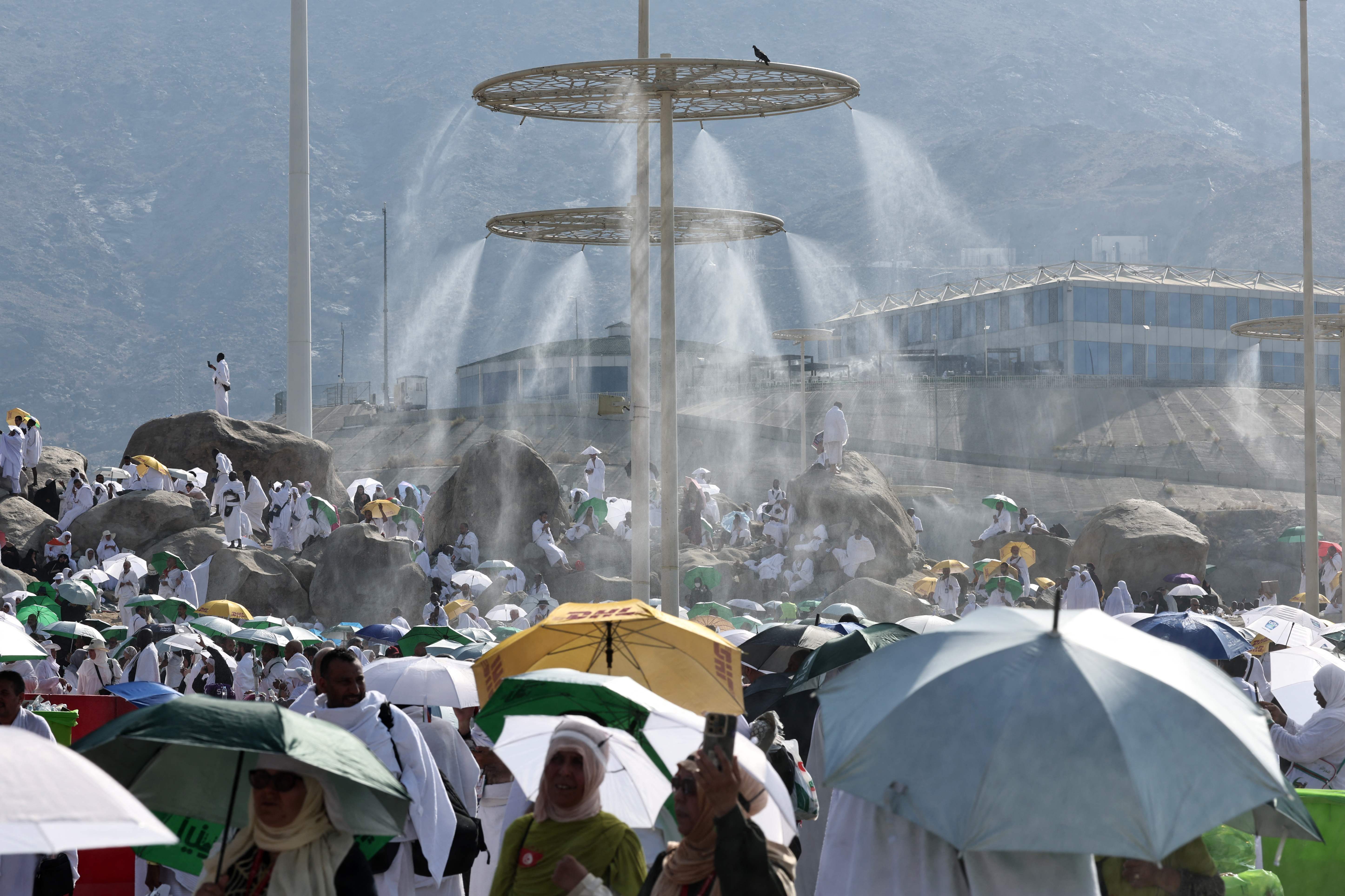 (FILES) Mist dispensers refreshen Muslim pilgrims at the base of Saudi Arabia's Mount Arafat, also known as Jabal al-Rahma or Mount of Mercy, during the climax of the Hajj pilgrimage on June 15, 2024. Arab diplomats on June 18, 2024, told AFP at least 550 pilgrims died this year, the majority due to heat-related illnesses after temperatures reached 51.8 degrees Celsius (125 Fahrenheit) in Mecca, Islam's holiest city. The total reported dead so far is 645, according to an AFP tally of figures released by various countries. About 1.8 million people attended the pilgrimage.About 1.8 million people attended the Hajj pilgrimage. (Photo by FADEL SENNA / AFP)