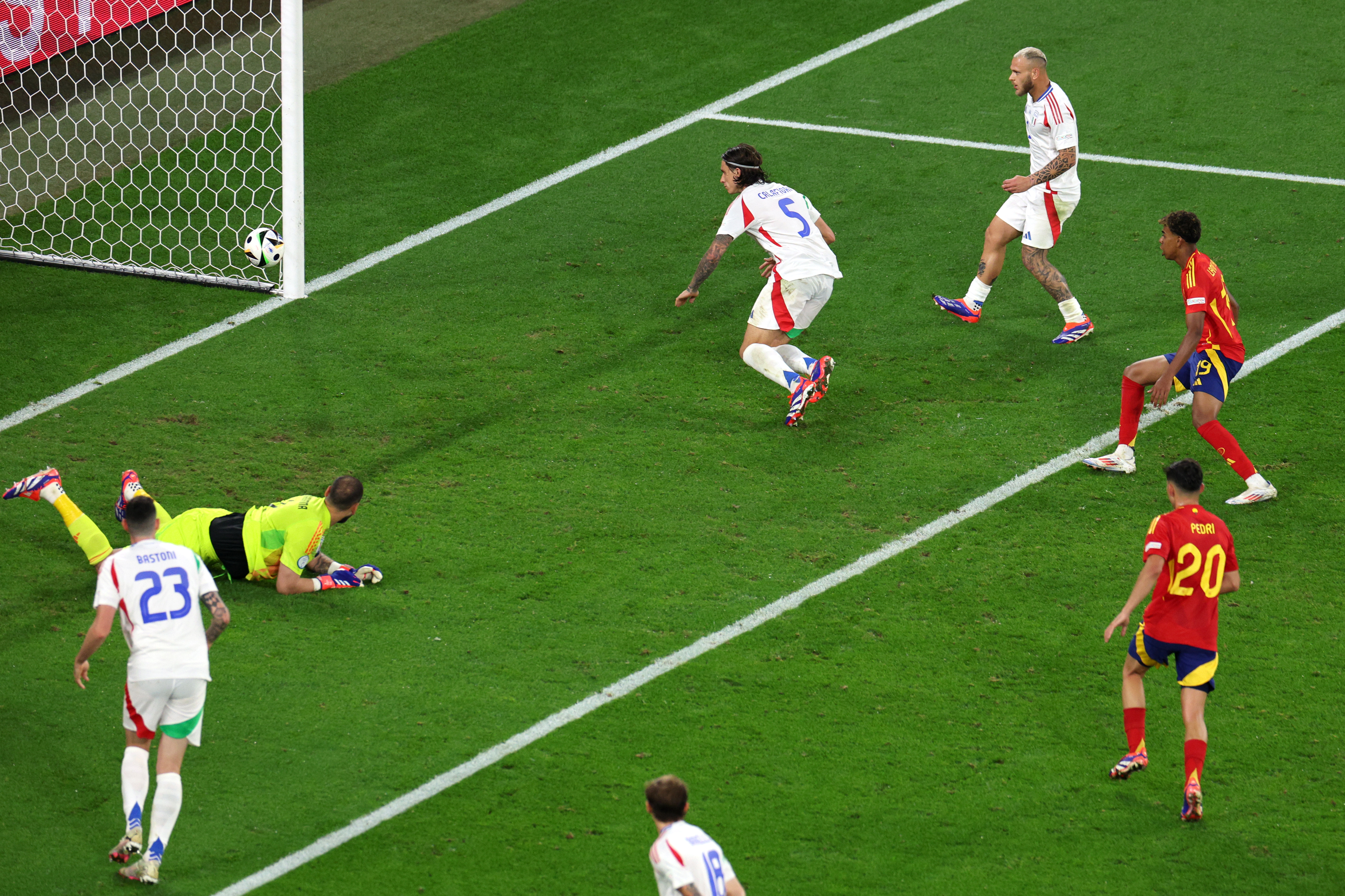 GELSENKIRCHEN, GERMANY - JUNE 20: Riccardo Calafiori of Italy concedes an own goal, the first goal for Spain, as Gianluigi Donnarumma of Italy looks on during the UEFA EURO 2024 group stage match between Spain and Italy at Arena AufSchalke on June 20, 2024 in Gelsenkirchen, Germany. (Photo by Dean Mouhtaropoulos/Getty Images)
