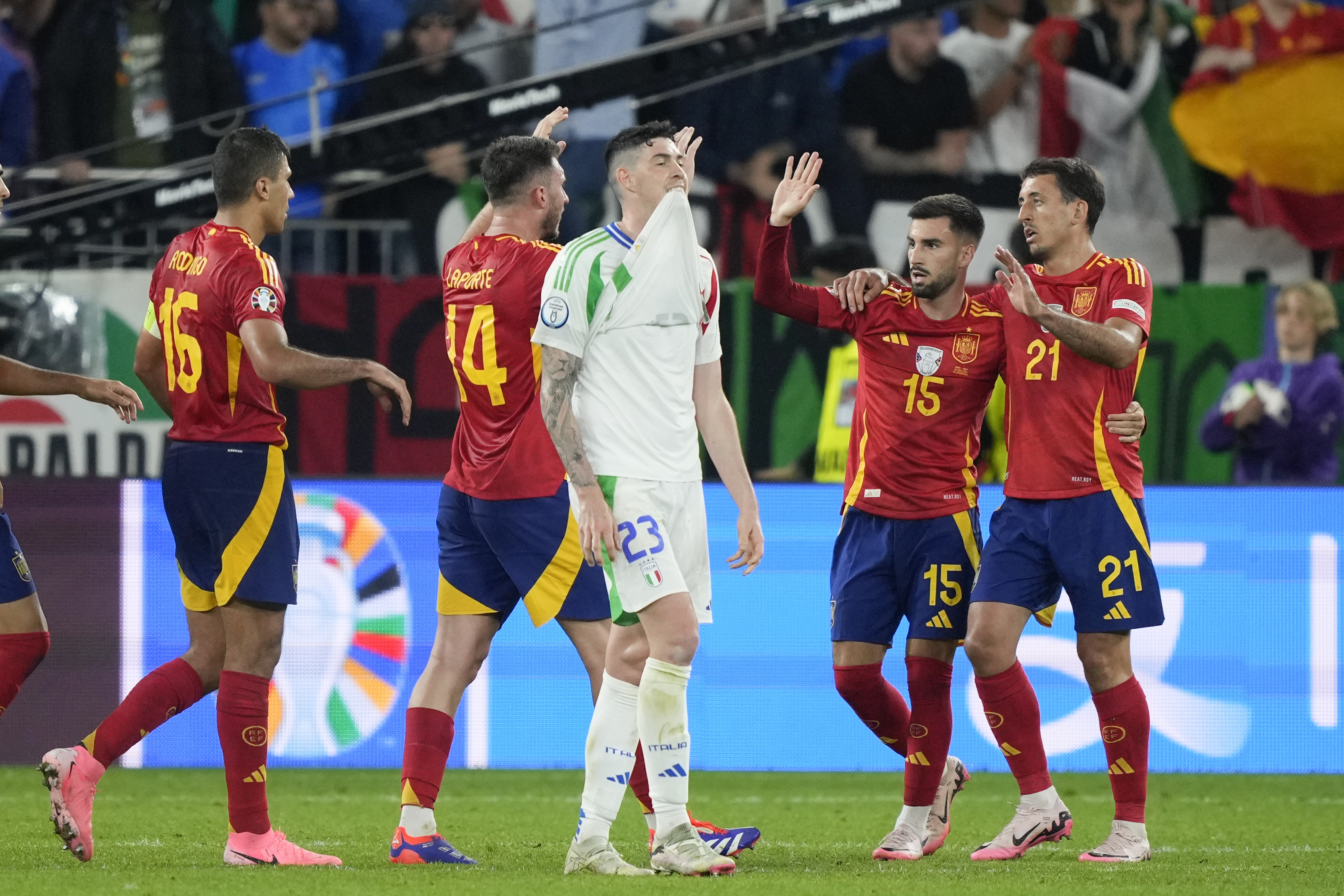 Italy's Alessandro Bastoni (23) walks past Spain player after a Group B match between Spain and Italy at the Euro 2024 soccer tournament in Gelsenkirchen, Germany, Thursday, June 20, 2024. (AP Photo/Martin Meissner)