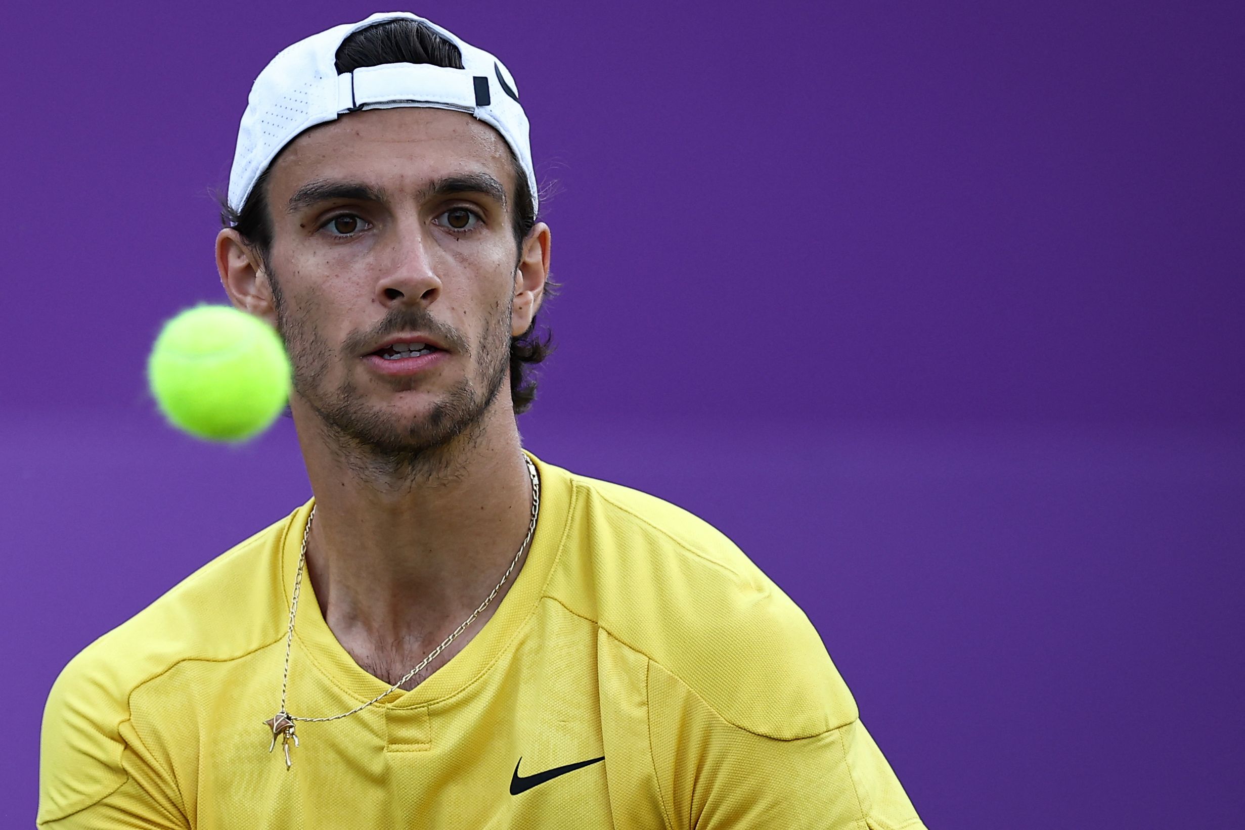 Italy's Lorenzo Musetti hits a return to Britain's Billy Harris during their men's singles quarter-finals tennis match at the Cinch ATP tennis Championships at Queen's Club in west London on June 21, 2024. (Photo by HENRY NICHOLLS / AFP)