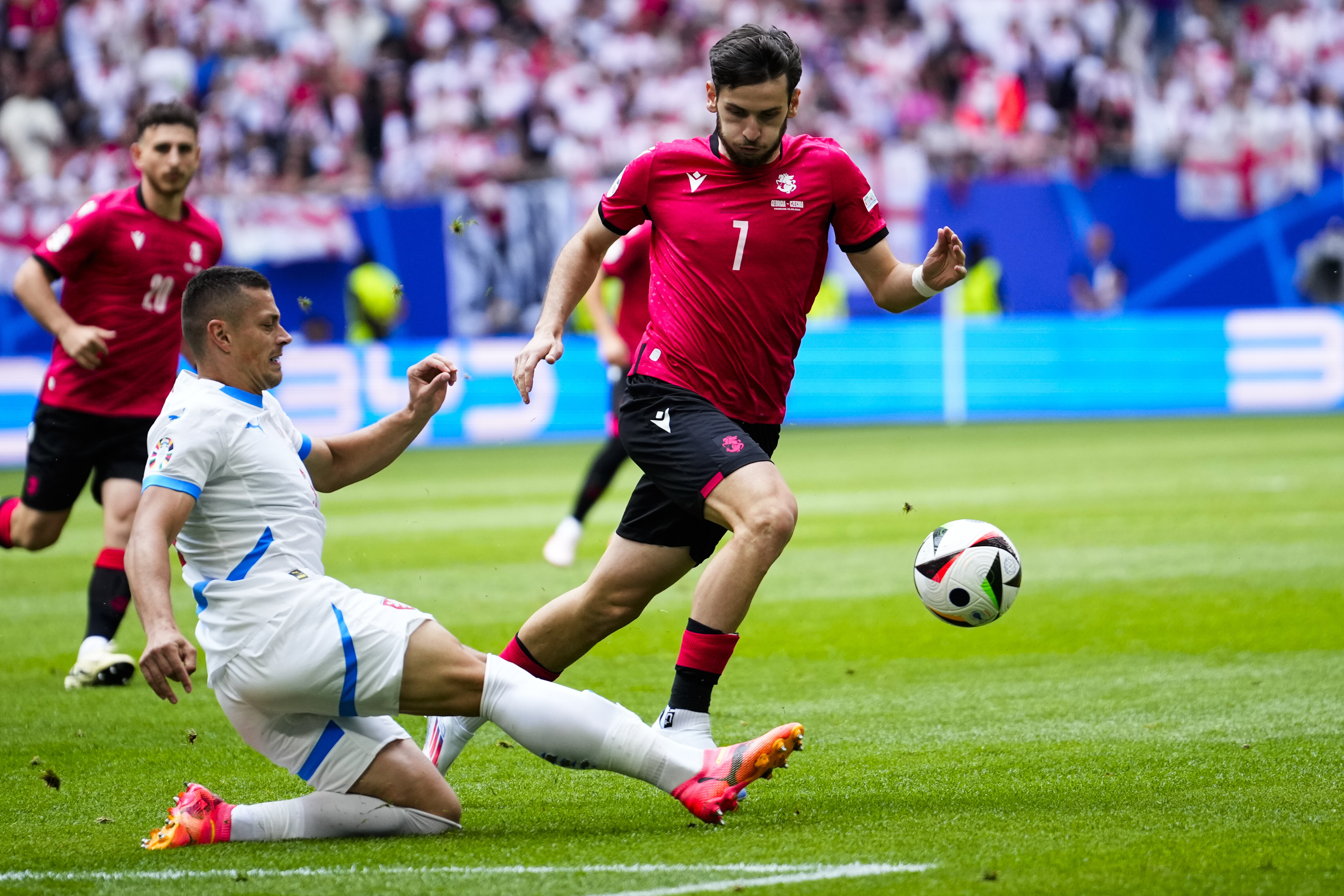 Czech Republic's Tomas Holes, left, and Georgia's Khvicha Kvaratskhelia challenge for the ball during a Group F match between Georgia and the Czech Republic at the Euro 2024 soccer tournament in Hamburg, Germany, Saturday, June 22, 2024. (AP Photo/Ebrahim Noroozi)