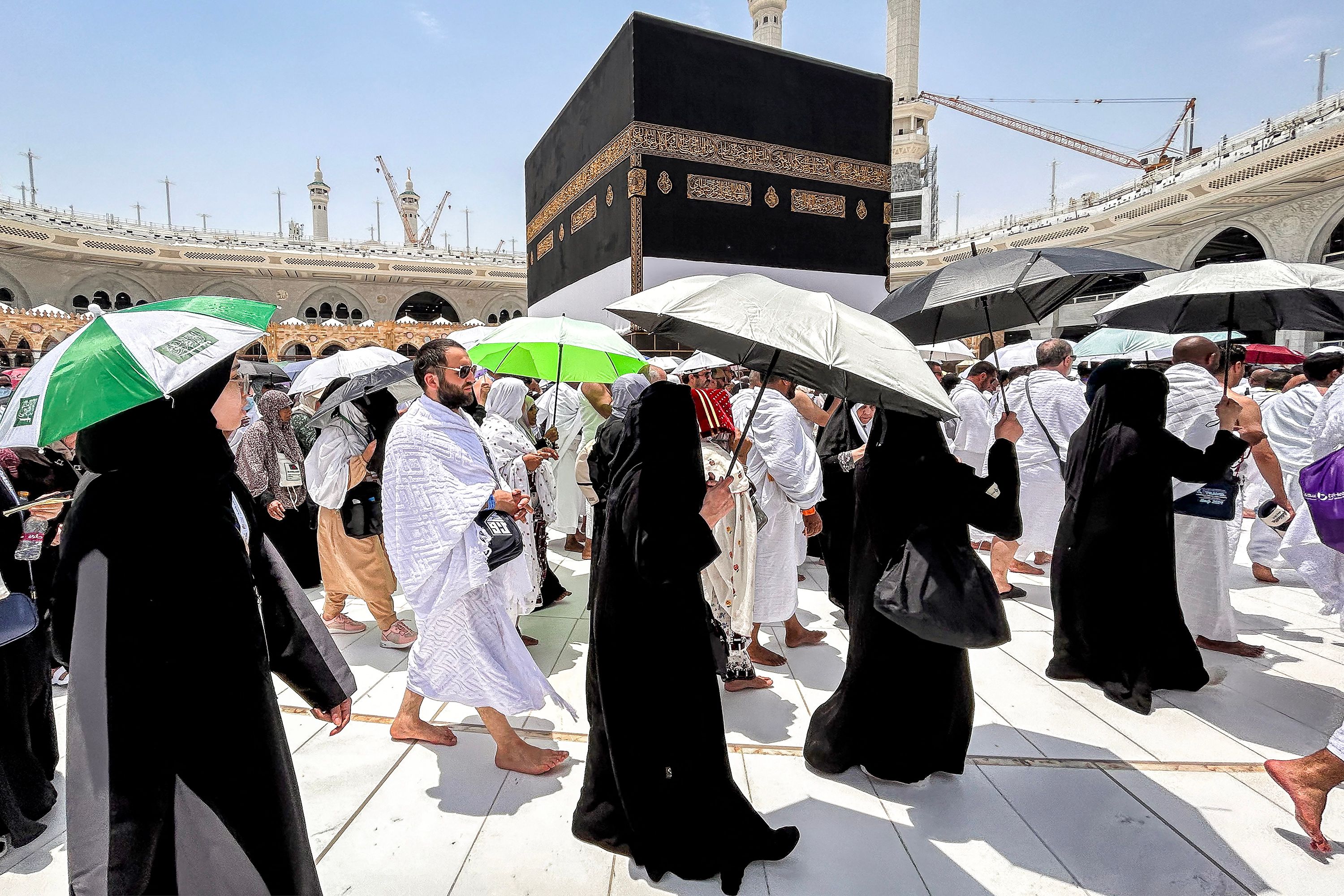 (FILES) Muslim devotees walk around the Kaaba, Islam's holiest shrine, at the Grand Mosque in Saudi Arabia's holy city of Mecca on June 13, 2024, ahead of the annual Hajj pilgrimage. Friends and family searched for missing hajj pilgrims on June 19 as the death toll at the annual rituals, which were carried out in scorching heat, surged past 900. (Photo by FADEL SENNA / AFP)