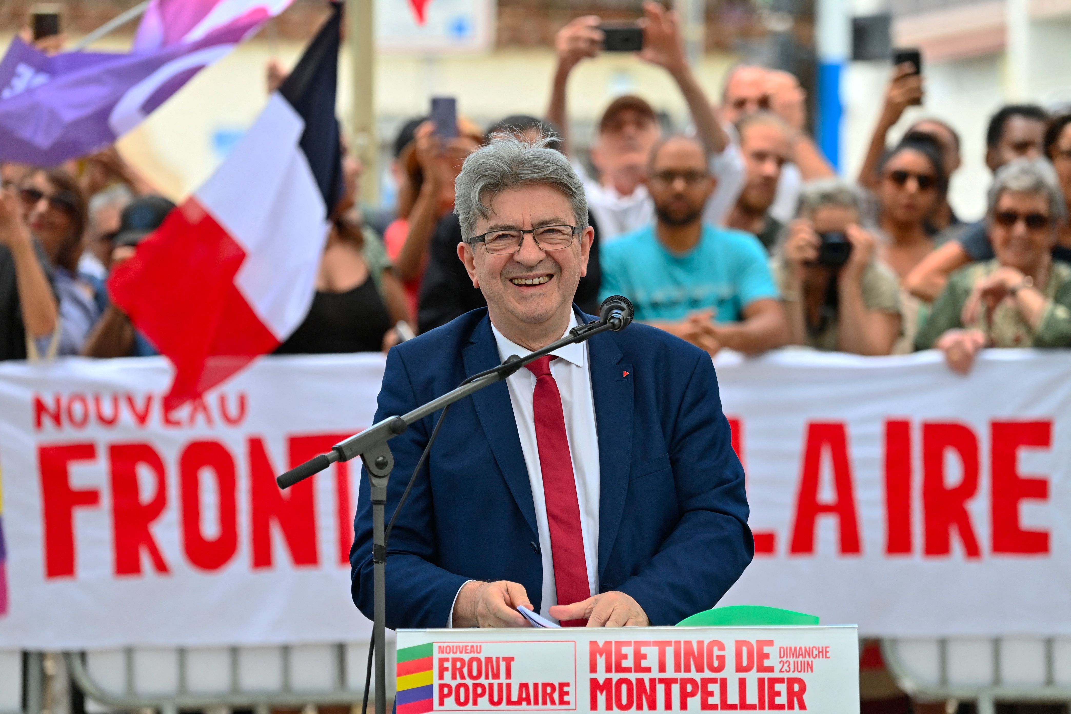TOPSHOT - La France Insoumise leader Jean-Luc Melenchon reacts during a meeting in support of 2024 legislative elections candidate French leftist party La France Insoumise (LFI) deputy Nathalie Oziol (unseen) and French leftist La France Insoumise (LFI) party member of parliament Sylvain Carriere (unseen) in Montpellier southern France on June 23, 2024. (Photo by Sylvain THOMAS / AFP)