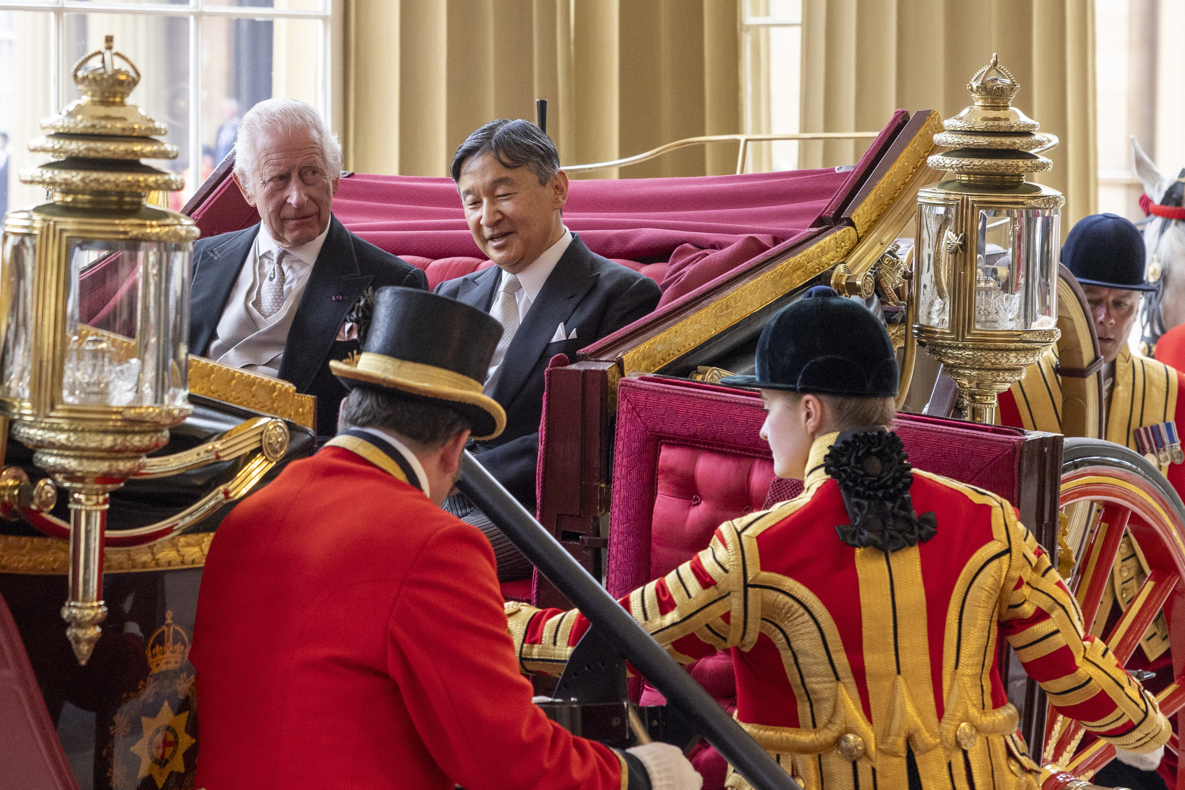 Britain's King Charles III and Japan's Emperor Naruhito arrive by carriage at Buckingham Palace, on the occasion of Naruhito's state visit to Britain, at Buckingham Palace, London, Tuesday, June 25, 2024. (Heathcliff O’Malley/Pool Photo via AP)