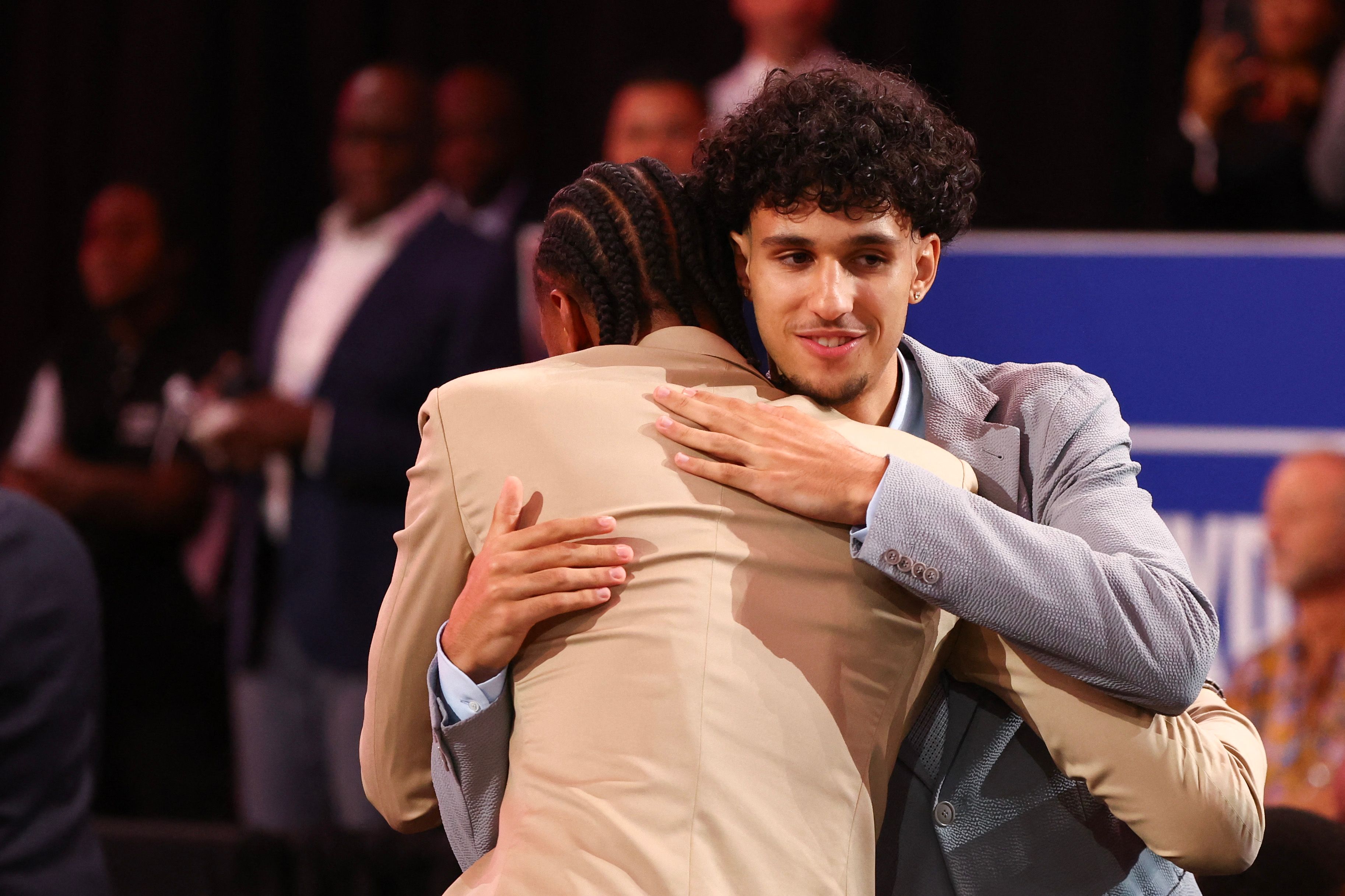 NEW YORK, NEW YORK - JUNE 26: Zaccharie Risacher celebrates with Alex Sarr after being drafted first overall pick by the Atlanta Hawks during the first round of the 2024 NBA Draft at Barclays Center on June 26, 2024 in the Brooklyn borough of New York City. NOTE TO USER: User expressly acknowledges and agrees that, by downloading and or using this photograph, User is consenting to the terms and conditions of the Getty Images License Agreement.   Sarah Stier/Getty Images/AFP (Photo by Sarah Stier / GETTY IMAGES NORTH AMERICA / Getty Images via AFP)