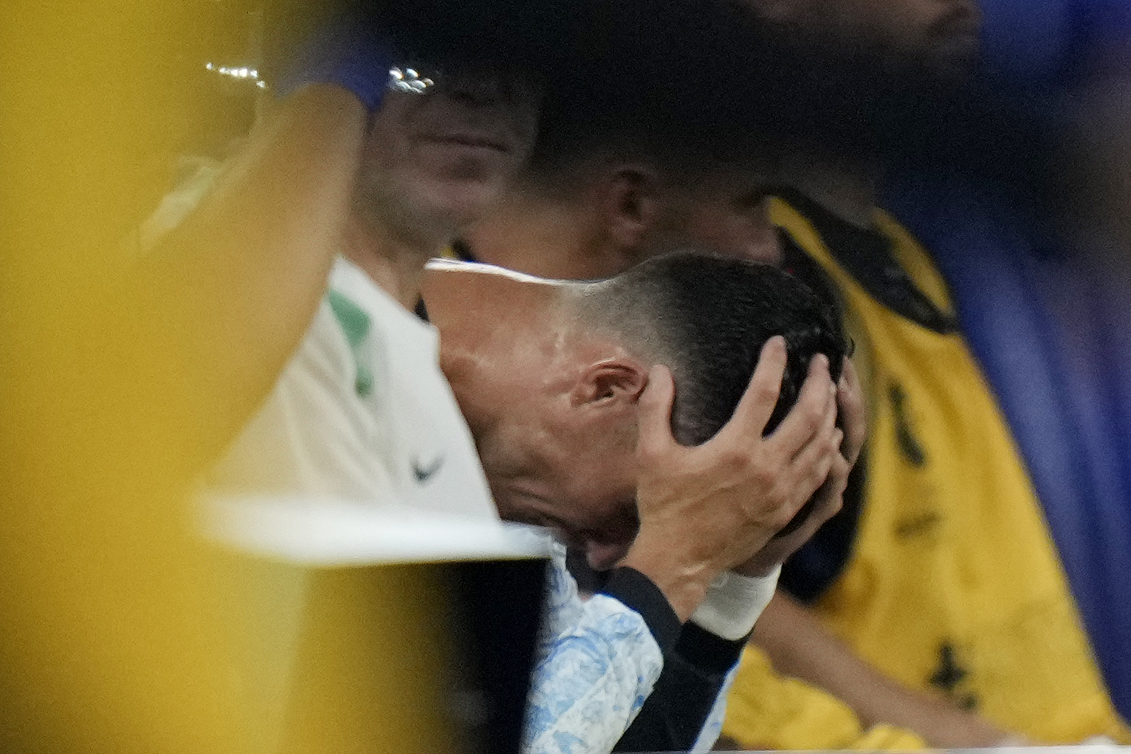 Portugal's Cristiano Ronaldo holds his head on the bench after leaving the pitch during a Group F match between Georgia and Portugal at the Euro 2024 soccer tournament in Gelsenkirchen, Germany, Wednesday, June 26, 2024. (AP Photo/Alessandra Tarantino)