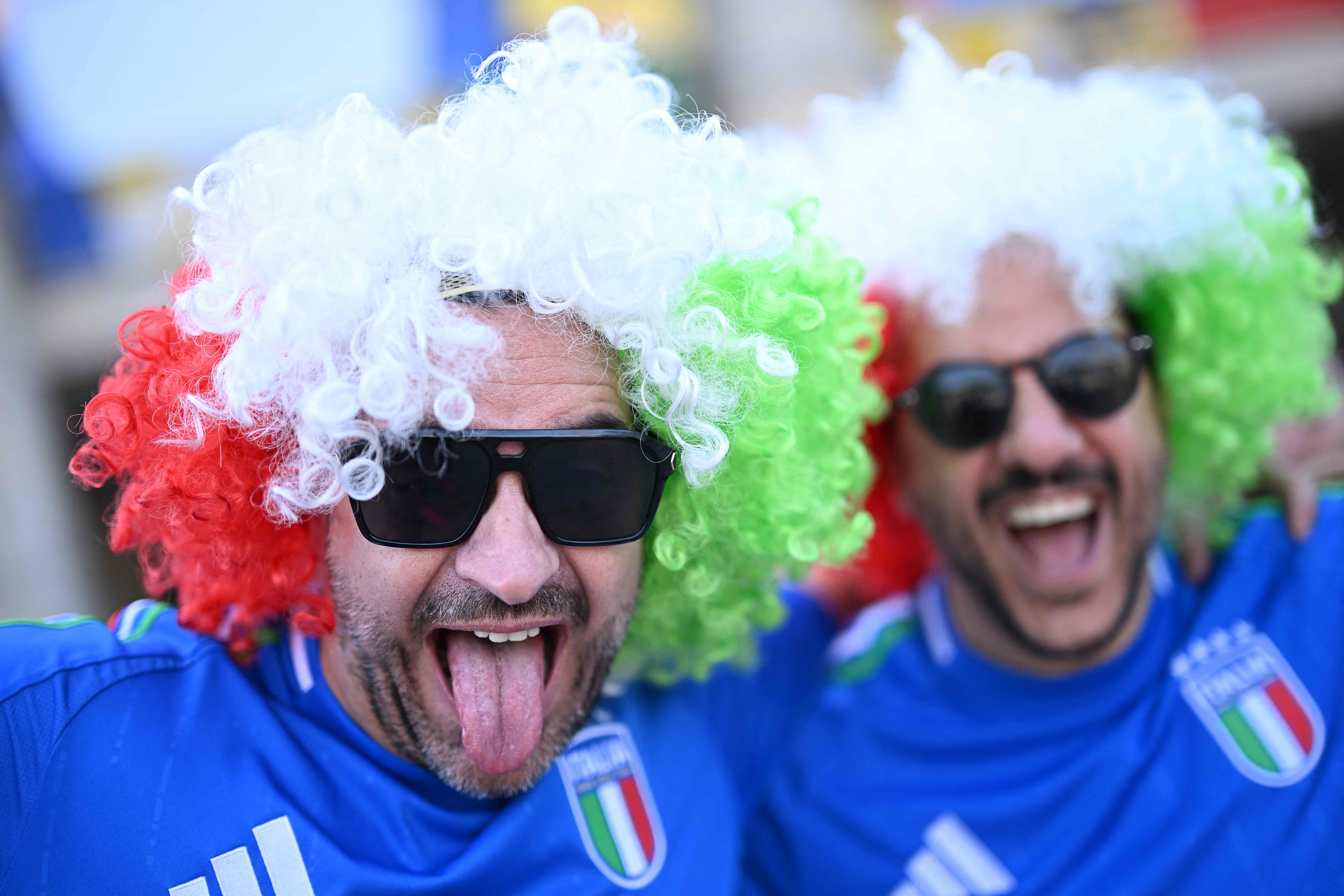 Italy's supporters wearing wigs in the color of the Italian flag pose as they arrive at the stadium ahead of the UEFA Euro 2024 round of 16 football match between Switzerland and Italy at the Olympiastadion Berlin in Berlin on June 29, 2024. (Photo by Kirill KUDRYAVTSEV / AFP)