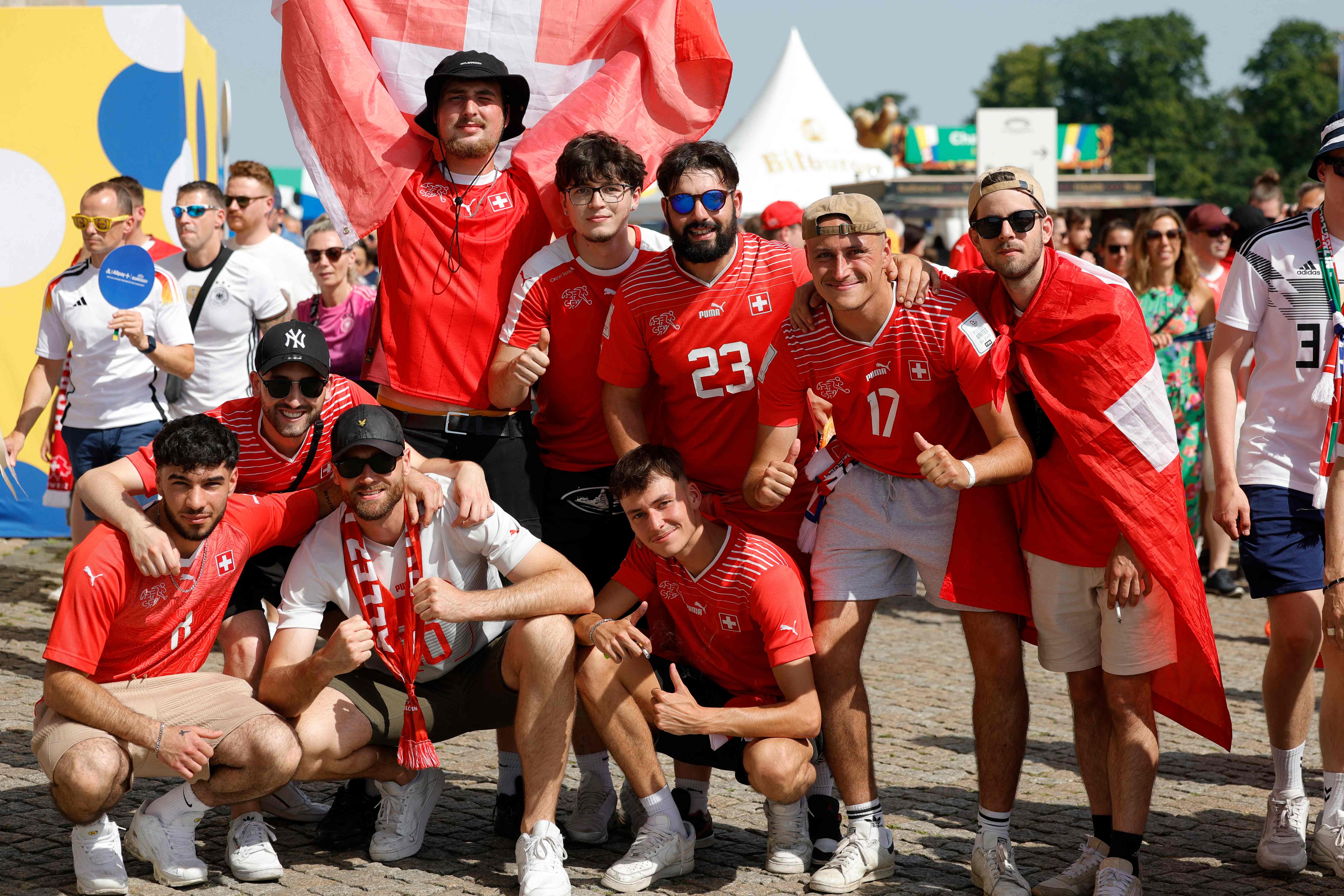 Switzerland fans pose for a picture as they arrive for the UEFA Euro 2024 round of 16 football match between Switzerland and Italy at the Olympiastadion Berlin in Berlin on June 29, 2024. (Photo by Axel HEIMKEN / AFP)