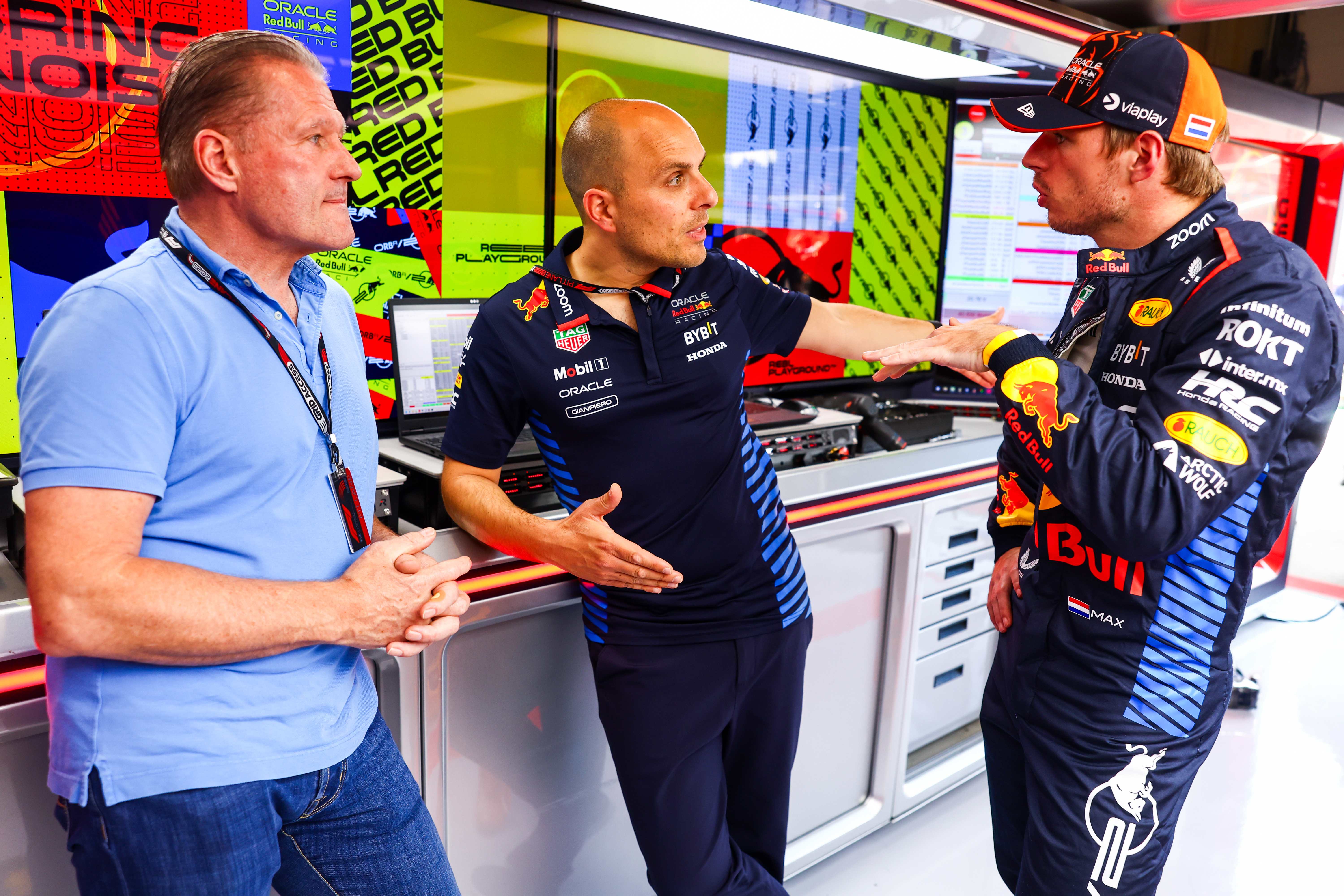 SPIELBERG, AUSTRIA - JUNE 27: Max Verstappen of the Netherlands and Oracle Red Bull Racing, race engineer Gianpiero Lambiase and Jos Verstappen talk in the garage during previews ahead of the F1 Grand Prix of Austria at Red Bull Ring on June 27, 2024 in Spielberg, Austria. (Photo by Mark Thompson/Getty Images)