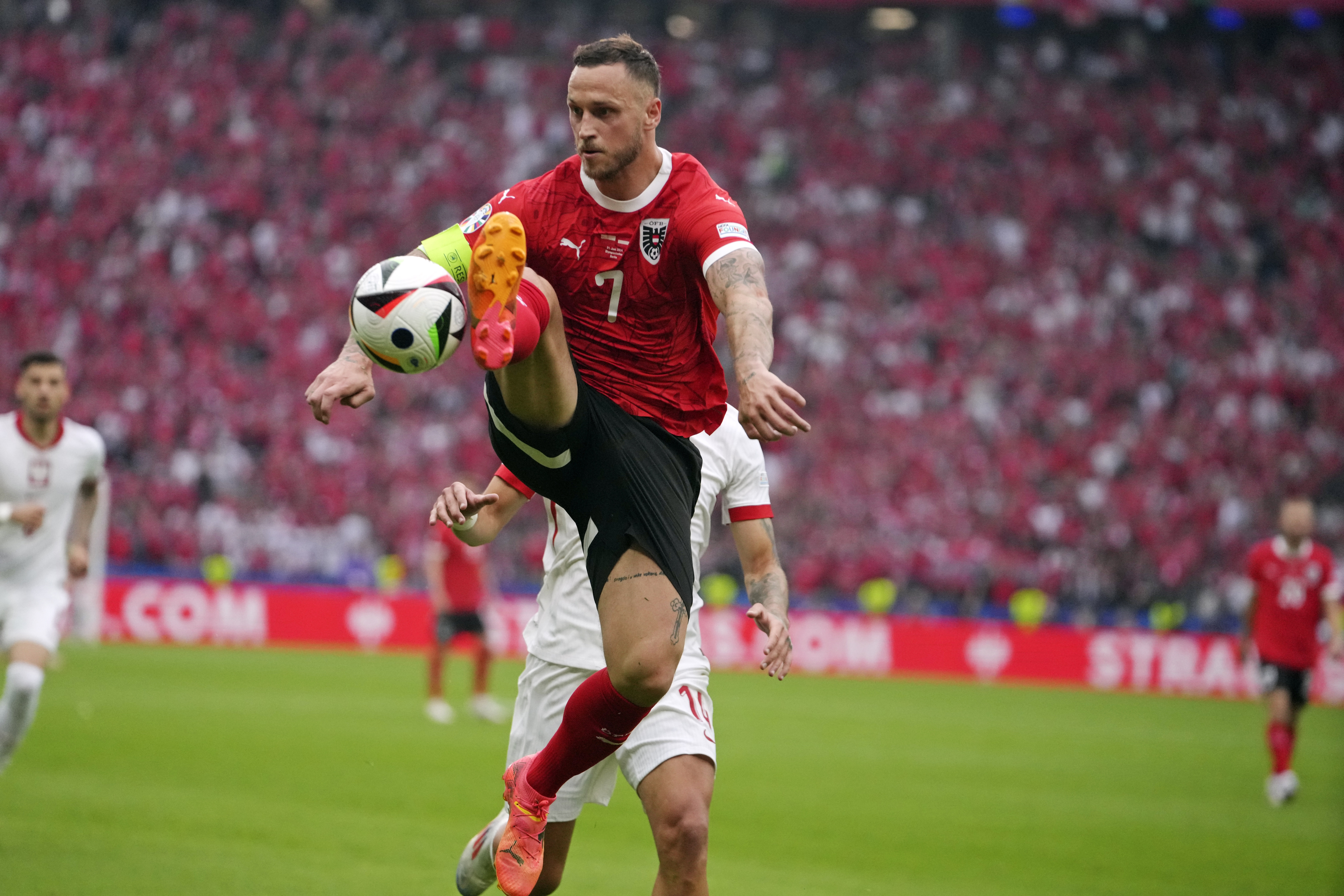 Austria's Marko Arnautovic (7) leaps to control the ball during a Group D match between Poland and Austria at the Euro 2024 soccer tournament in Berlin, Germany, Friday, June 21, 2024. (AP Photo/Sunday Alamba)