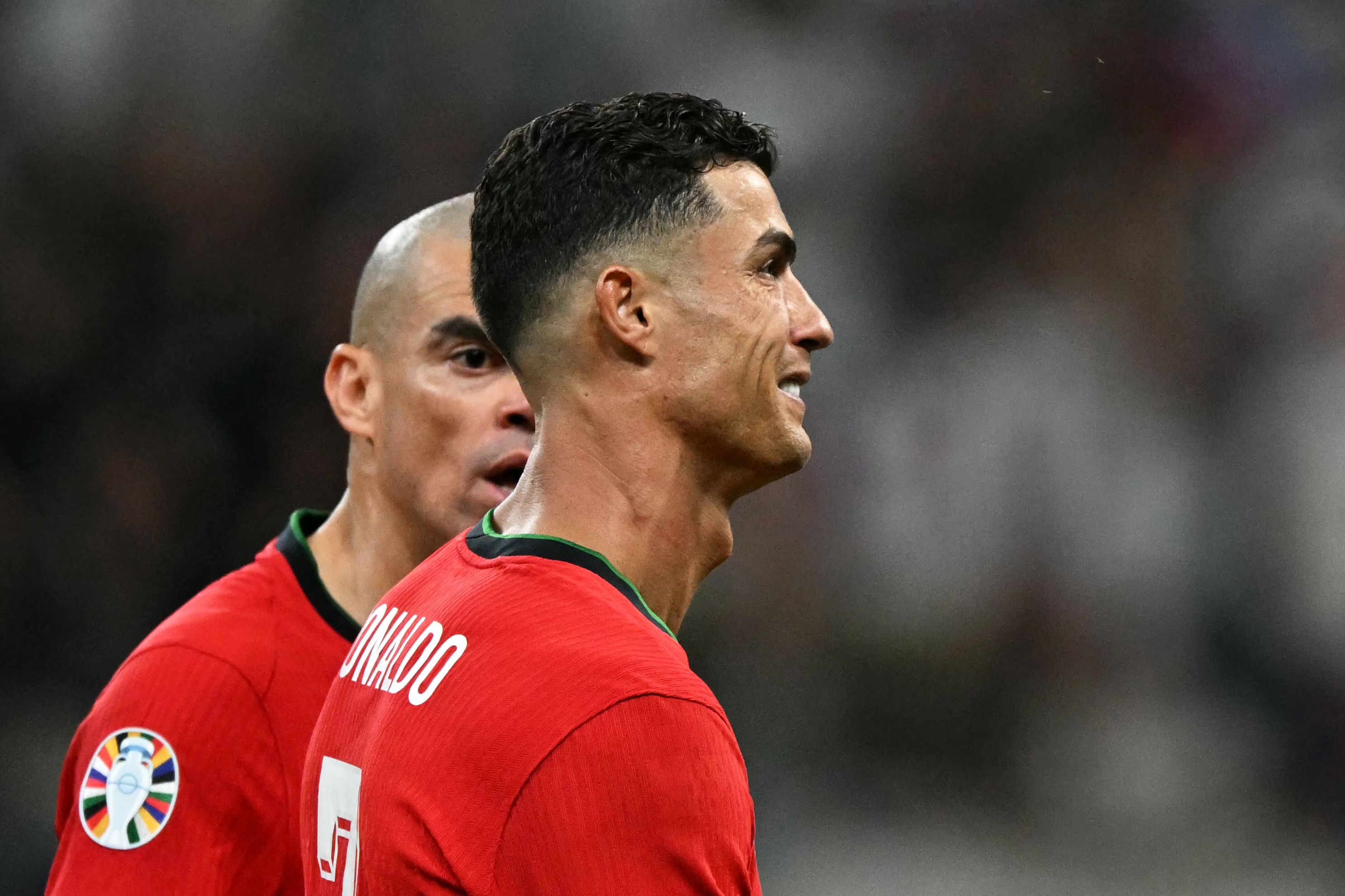 Portugal's forward #07 Cristiano Ronaldo (R) reacts with Portugal's defender #03 Pepe after missing a penalty kick during the UEFA Euro 2024 round of 16 football match between Portugal and Slovenia at the Frankfurt Arena in Frankfurt am Main on July 1, 2024. (Photo by PATRICIA DE MELO MOREIRA / AFP)