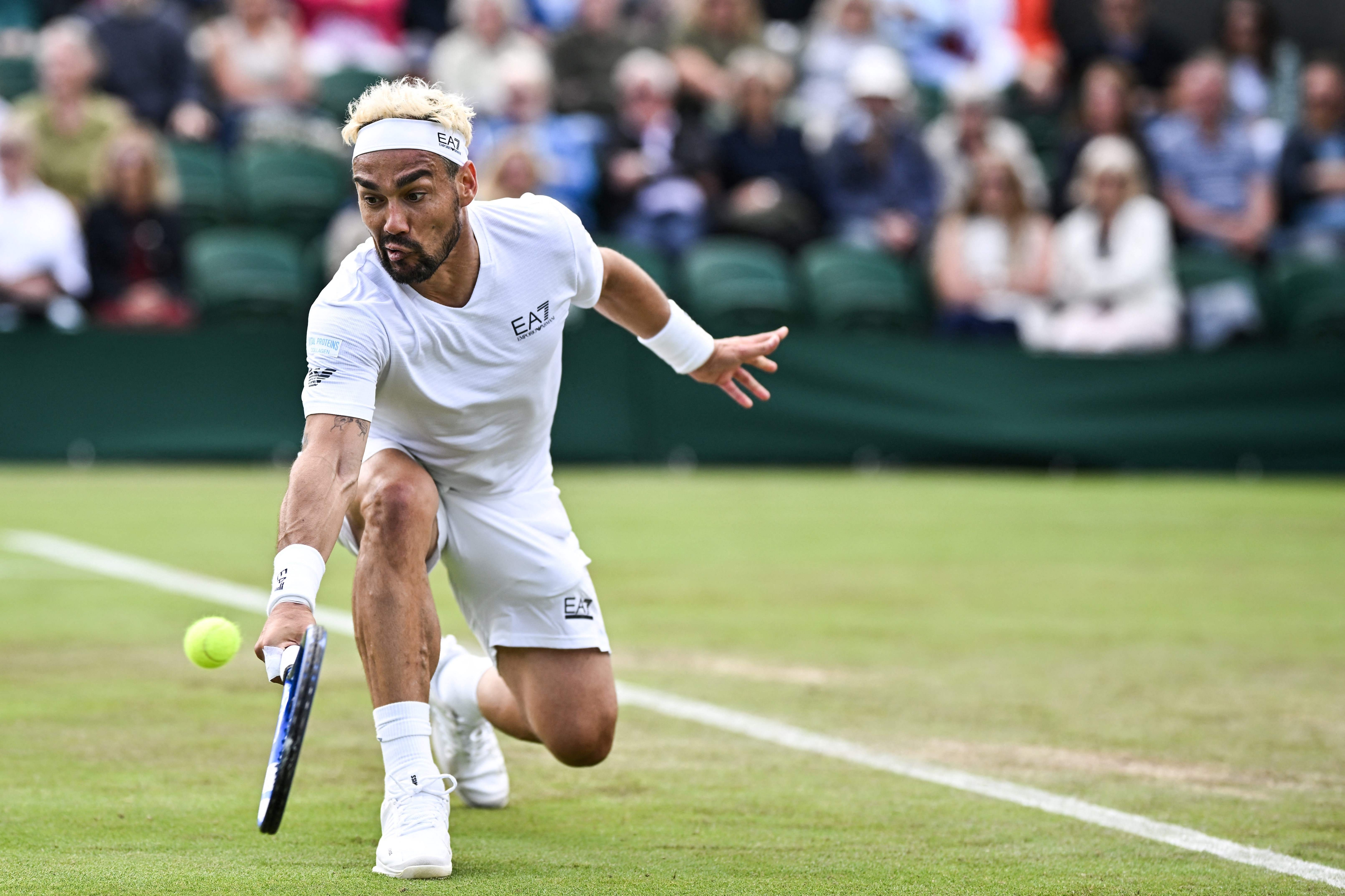 Italy's Fabio Fognini returns against Norway's Casper Ruud during their men's singles second round tennis match on the third day of the 2024 Wimbledon Championships at The All England Lawn Tennis and Croquet Club in Wimbledon, southwest London, on July 3, 2024. (Photo by Ben Stansall / AFP) / RESTRICTED TO EDITORIAL USE