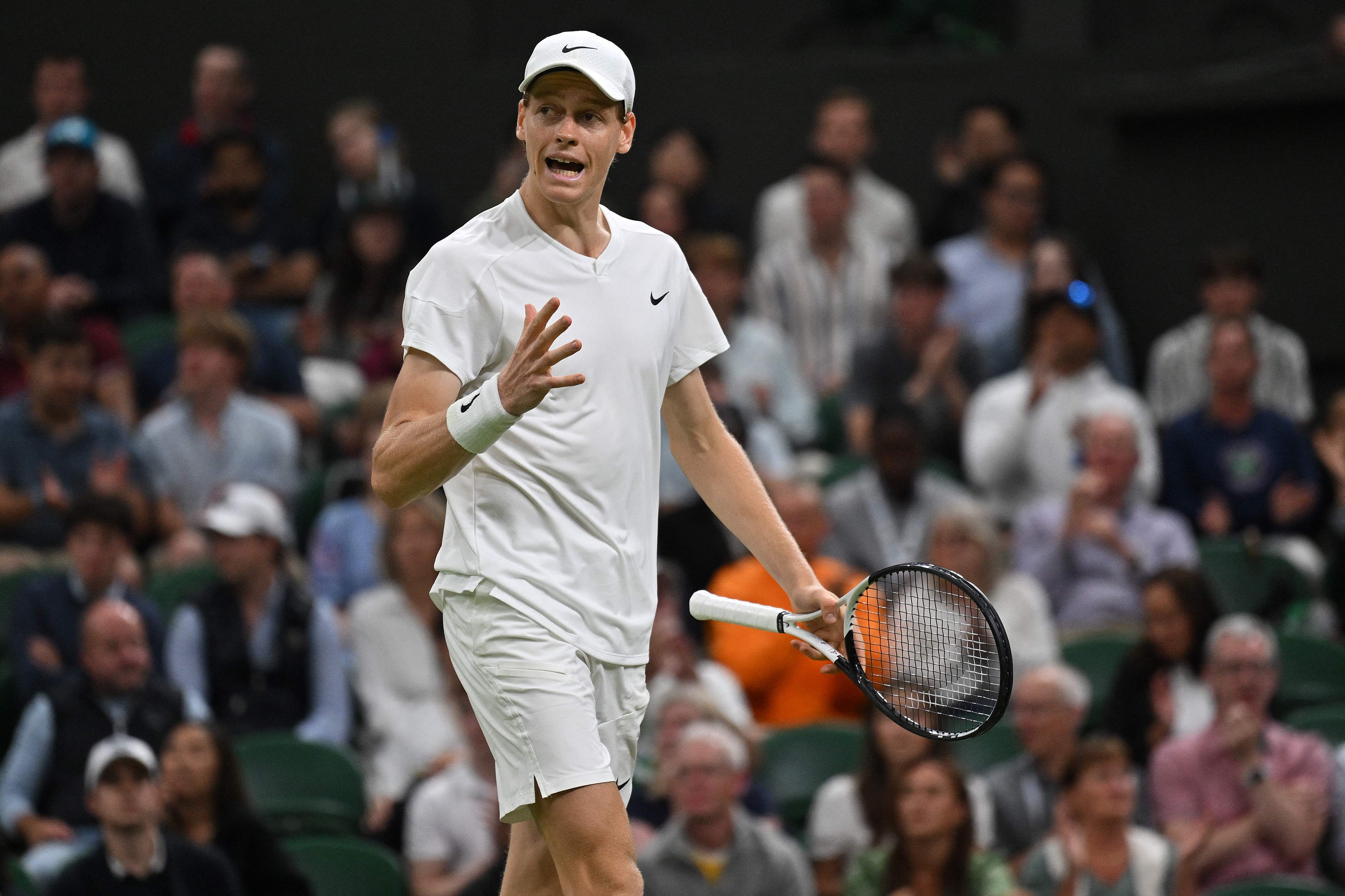 Italy's Jannik Sinner reacts during the tie-break in the fourth set against Italy's Matteo Berrettini during their men's singles second round tennis match on the third day of the 2024 Wimbledon Championships at The All England Lawn Tennis and Croquet Club in Wimbledon, southwest London, on July 3, 2024. (Photo by ANDREJ ISAKOVIC / AFP) / RESTRICTED TO EDITORIAL USE
