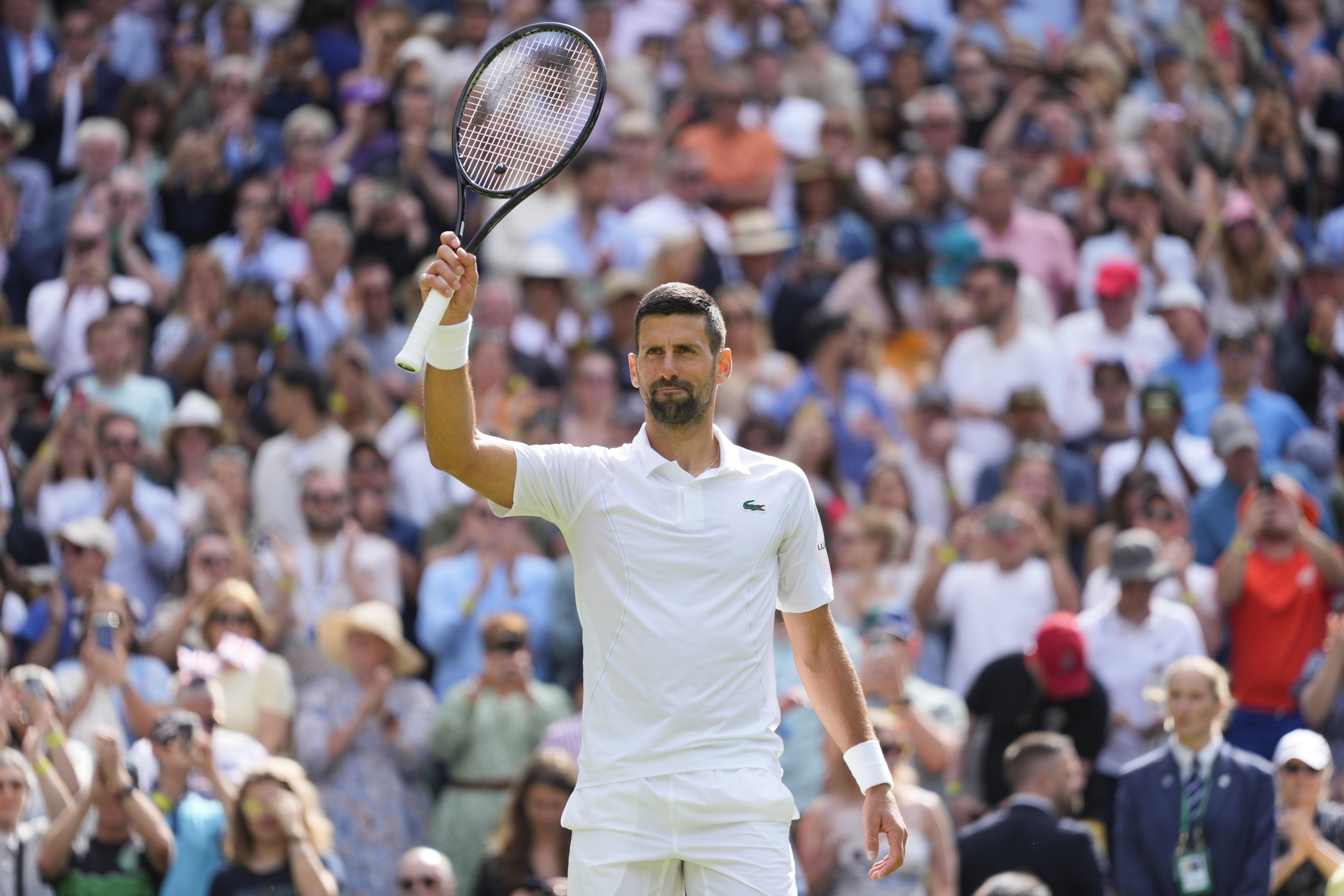 Serbia's Novak Djokovic waves after defeating Britain's Jacob Fearnley in their second round match at the Wimbledon tennis championships in London, Thursday, July 4, 2024. (AP Photo/Kirsty Wigglesworth)