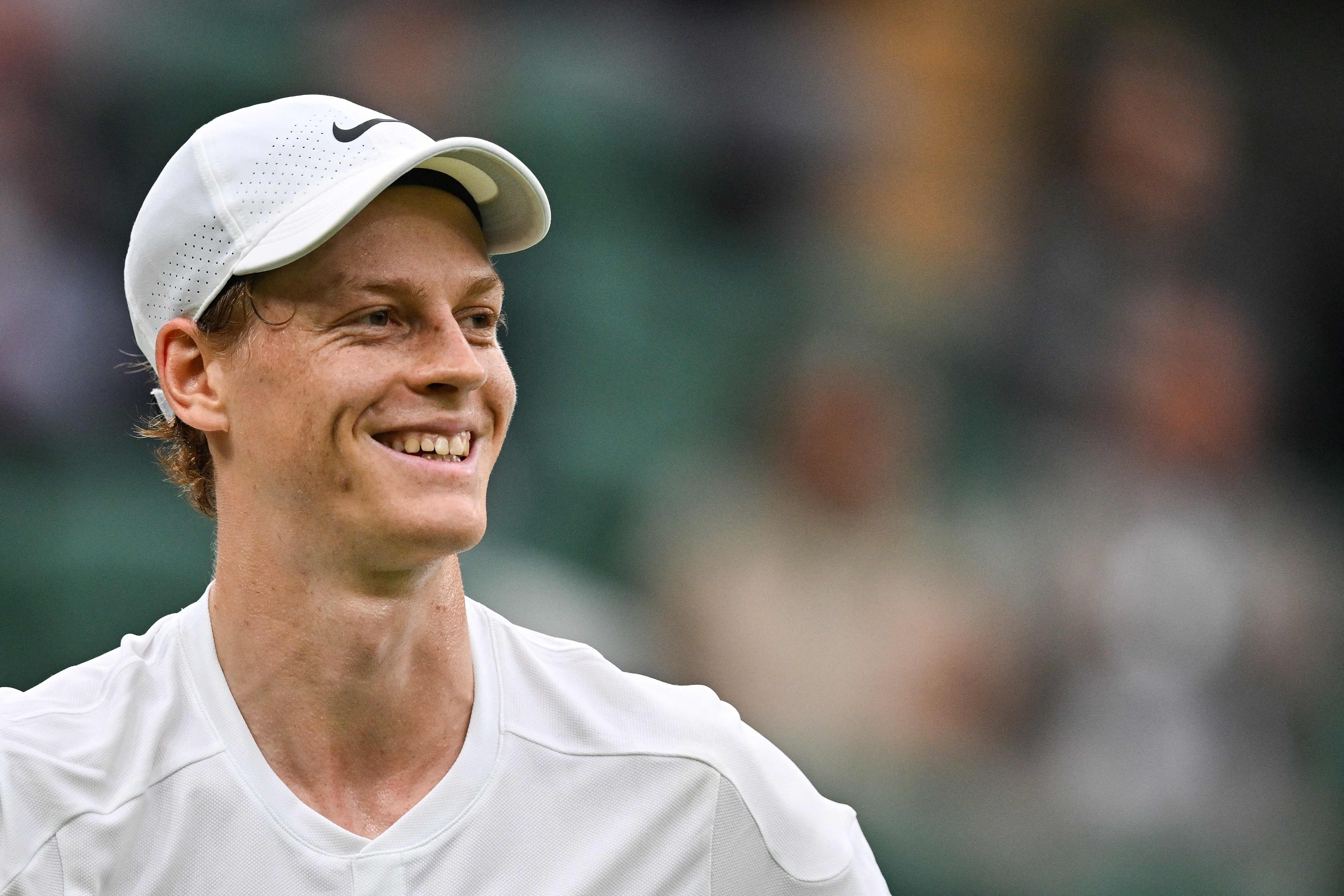 Italy's Jannik Sinner smiles as he plays against USA's Ben Shelton during their men's singles tennis match on the seventh day of the 2024 Wimbledon Championships at The All England Lawn Tennis and Croquet Club in Wimbledon, southwest London, on July 7, 2024. (Photo by ANDREJ ISAKOVIC / AFP) / RESTRICTED TO EDITORIAL USE