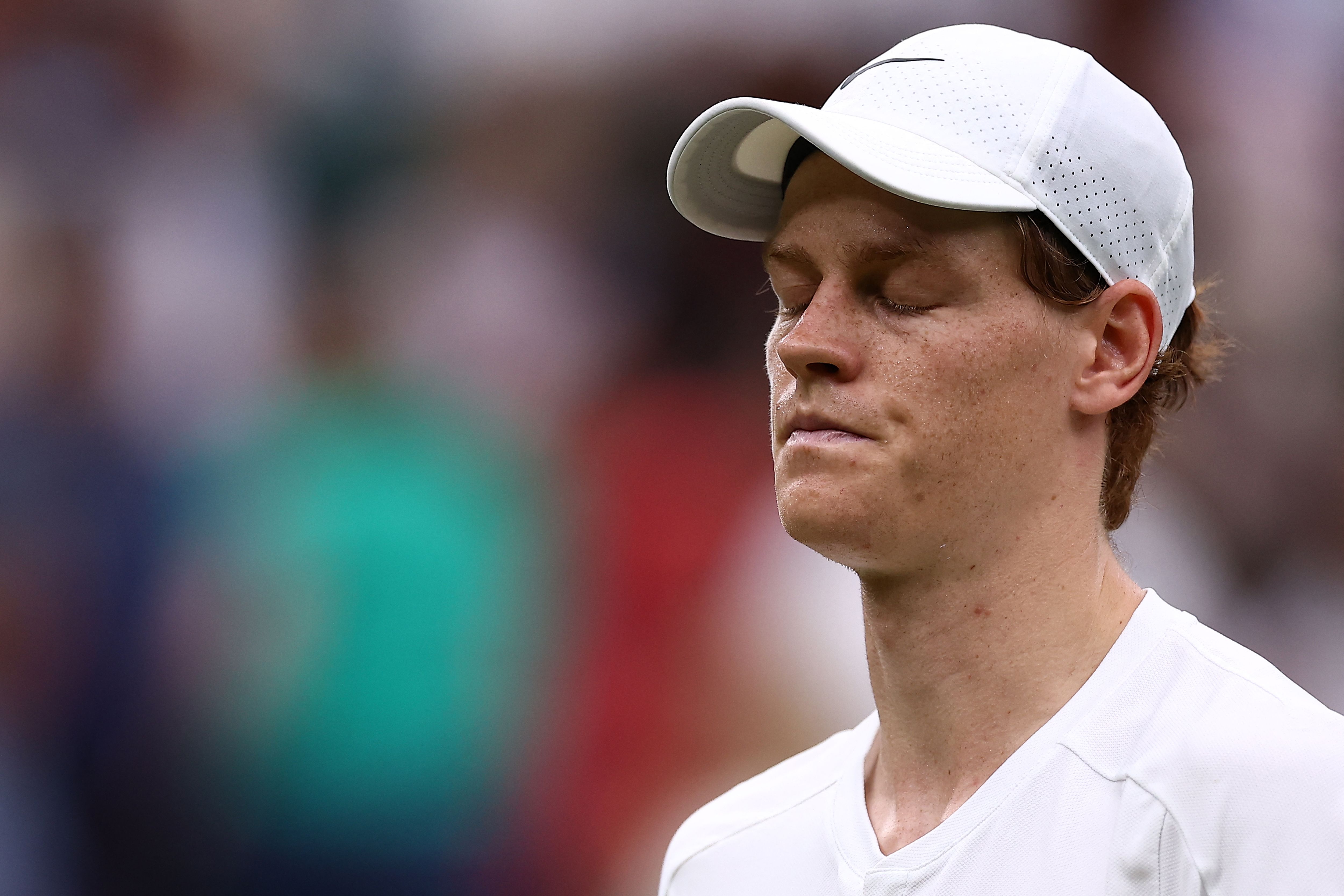 Italy's Jannik Sinner reacts reacts after losing a point against Russia's Daniil Medvedev during their men's singles quarter-final tennis match on the ninth day of the 2024 Wimbledon Championships at The All England Lawn Tennis and Croquet Club in Wimbledon, southwest London, on July 9, 2024. Medvedev won the match 6-7, 6-4, 7-6, 2-6 6-3. (Photo by HENRY NICHOLLS / AFP) / RESTRICTED TO EDITORIAL USE