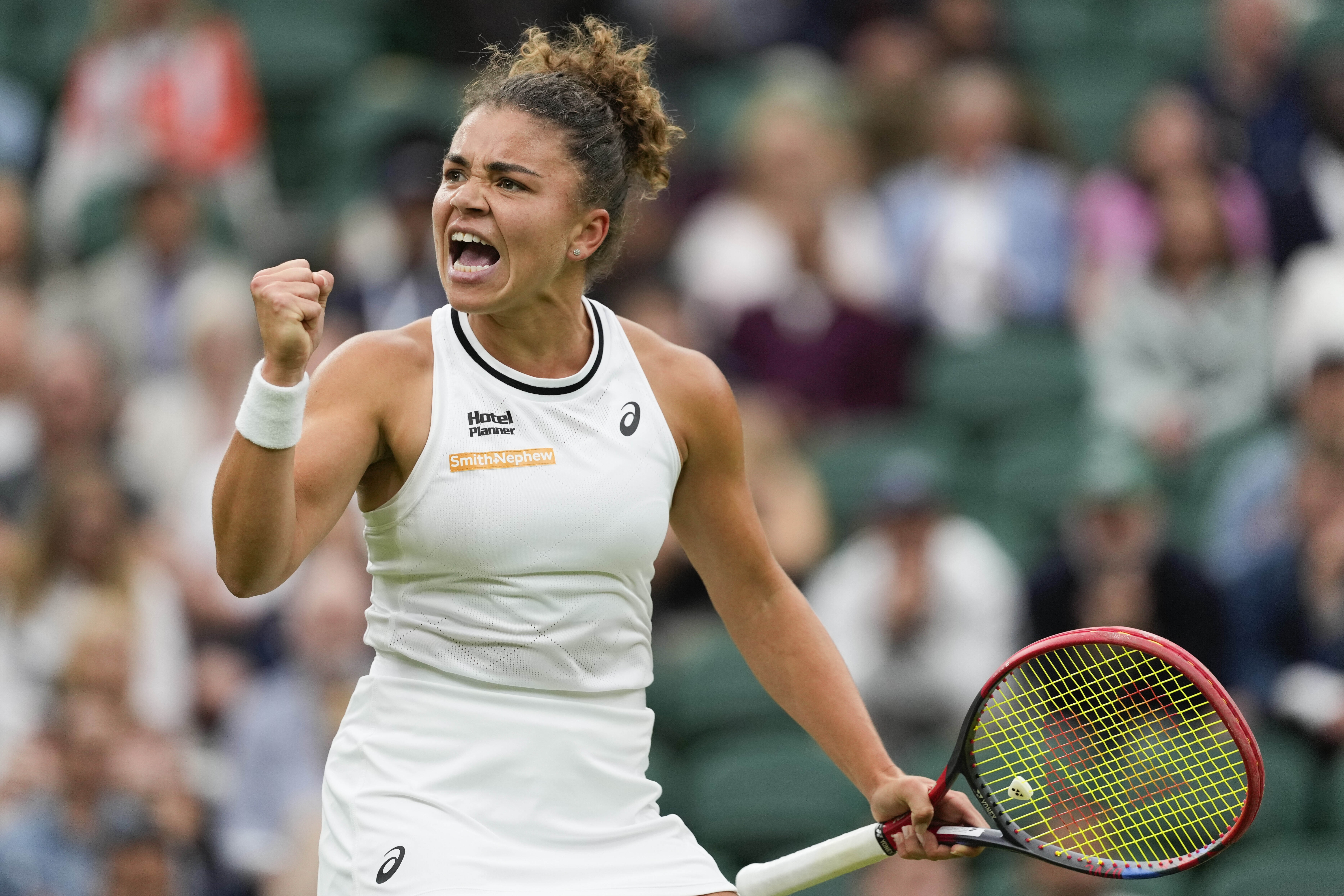Jasmine Paolini of Italy reacts after winning a point against Emma Navarro of the United States during their quarterfinal match at the Wimbledon tennis championships in London, Tuesday, July 9, 2024. (AP Photo/Alberto Pezzali)