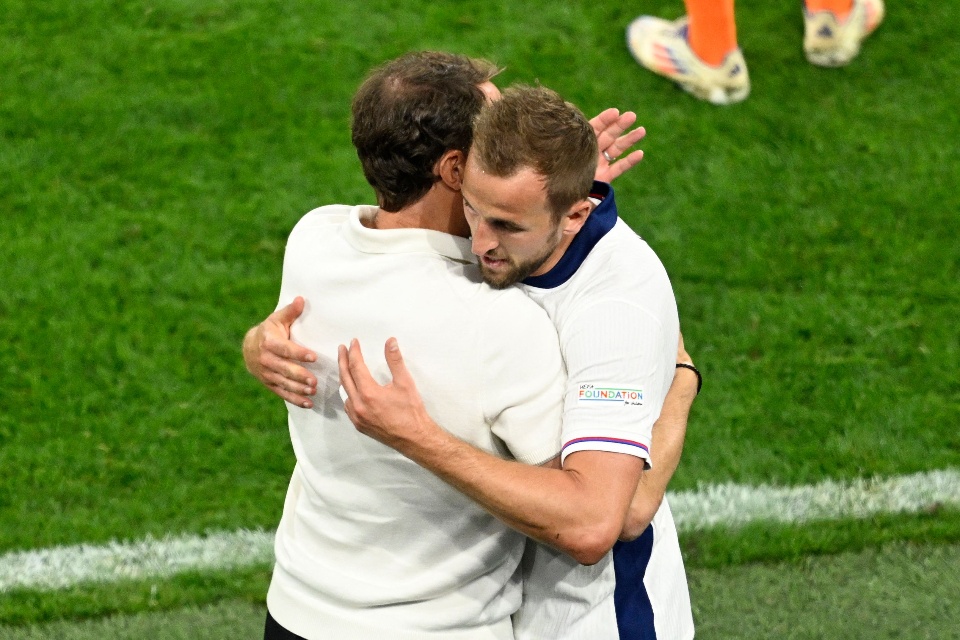 England's forward #09 Harry Kane is greeted by England's head coach Gareth Southgate as he leaves the pitch after being substituted during the UEFA Euro 2024 semi-final football match between the Netherlands and England at the BVB Stadion in Dortmund on July 10, 2024. (Photo by INA FASSBENDER / AFP)