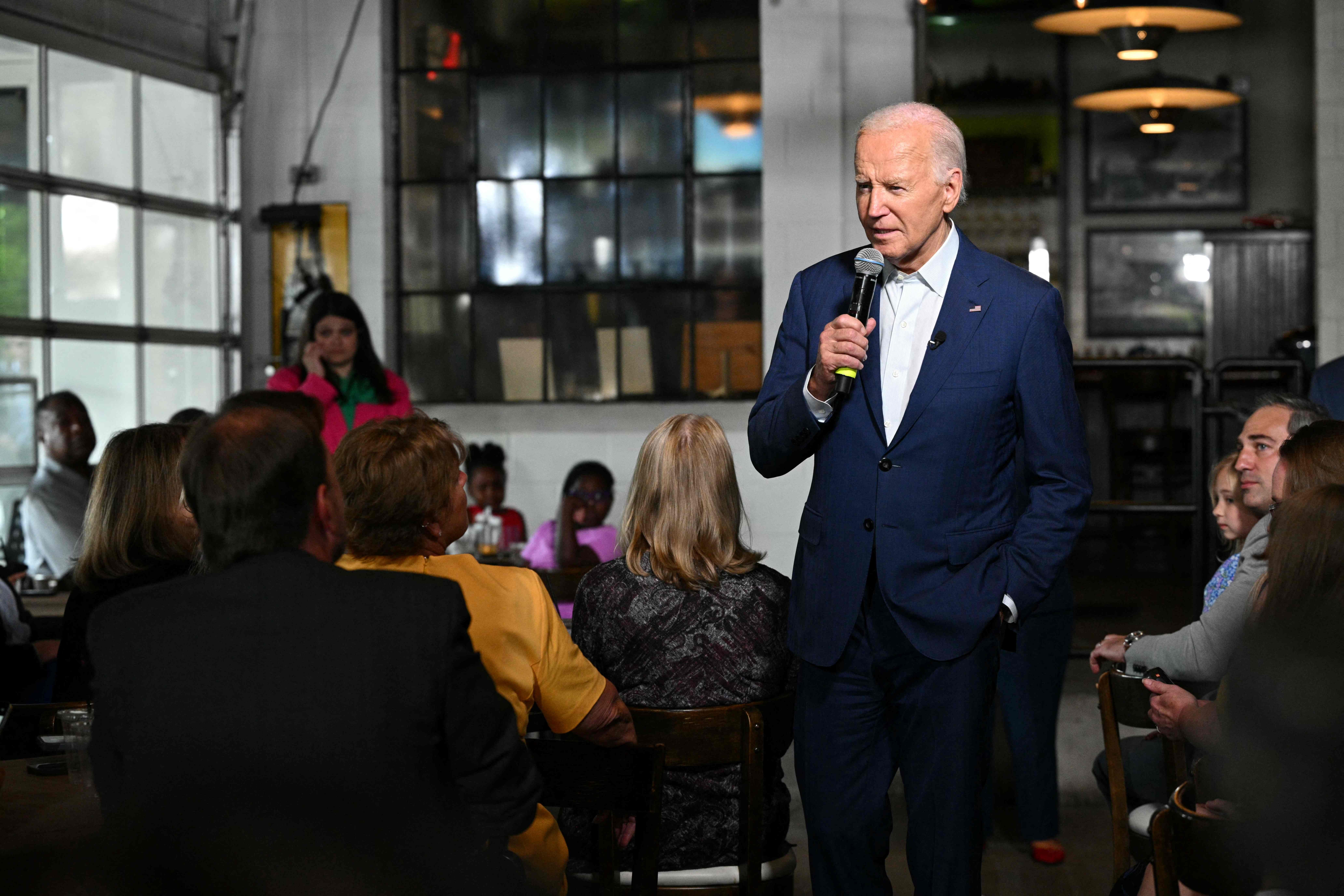 US President Joe Biden speaks during a stop at the Garage Grill & Fuel Bar in Northville, Michigan, ahead of a campaign event in Detroit on July 12, 2024. (Photo by Mandel NGAN / AFP)