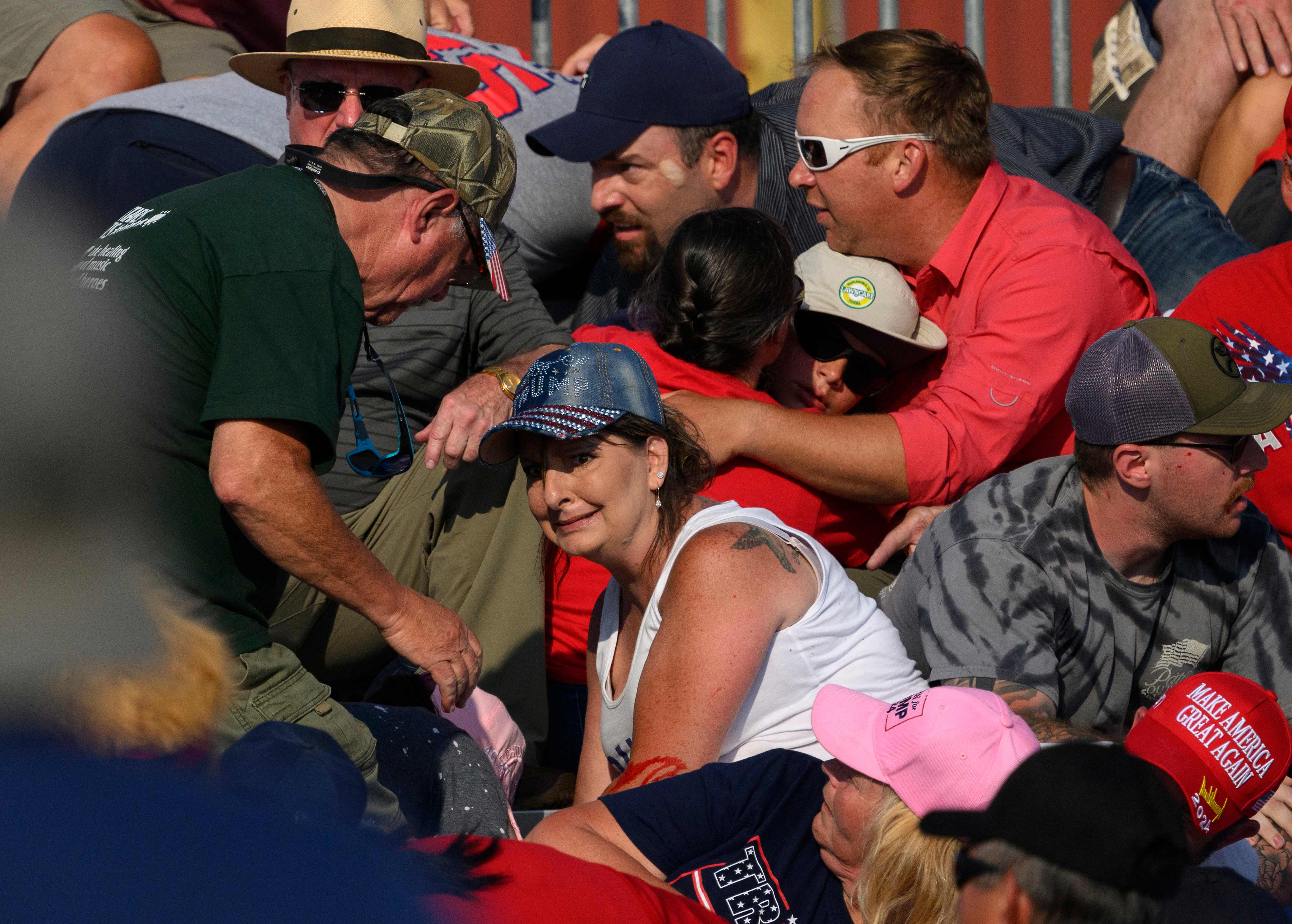 BUTLER, PENNSYLVANIA - JULY 13: Helen Comperatore, wife of Corey Comperatore, calls for aid moments after Thomas Matthew Crooks opened fire on former president Donald Trump during a campaign rally at Butler Farm Show Inc. on July 13, 2024 in Butler, Pennsylvania. Corey Comperatore, a 50-year-old retired firefighter, was killed and two others were severely injured in the assassination attempt on the former president.   Jeff Swensen/Getty Images/AFP (Photo by JEFF SWENSEN / GETTY IMAGES NORTH AMERICA / Getty Images via AFP)