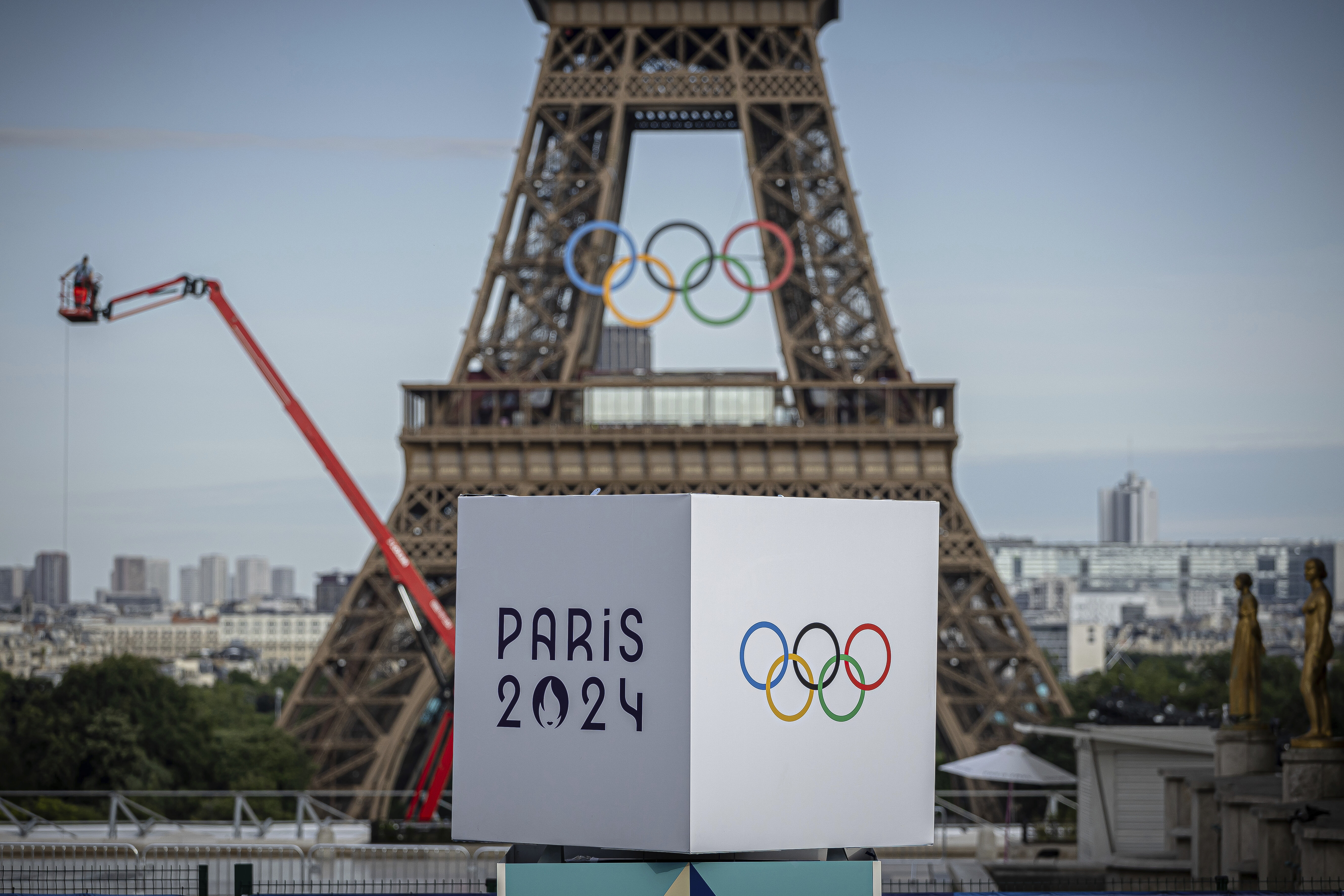The Olympic rings are seen on the Eiffel Tower, Sunday, July 14, 2024, in Paris. The Paris Olympics organizers mounted the rings on the Eiffel Tower on Friday as the French capital marks 50 days until the start of the Summer Games. (AP Photo/Aurelien Morissard)