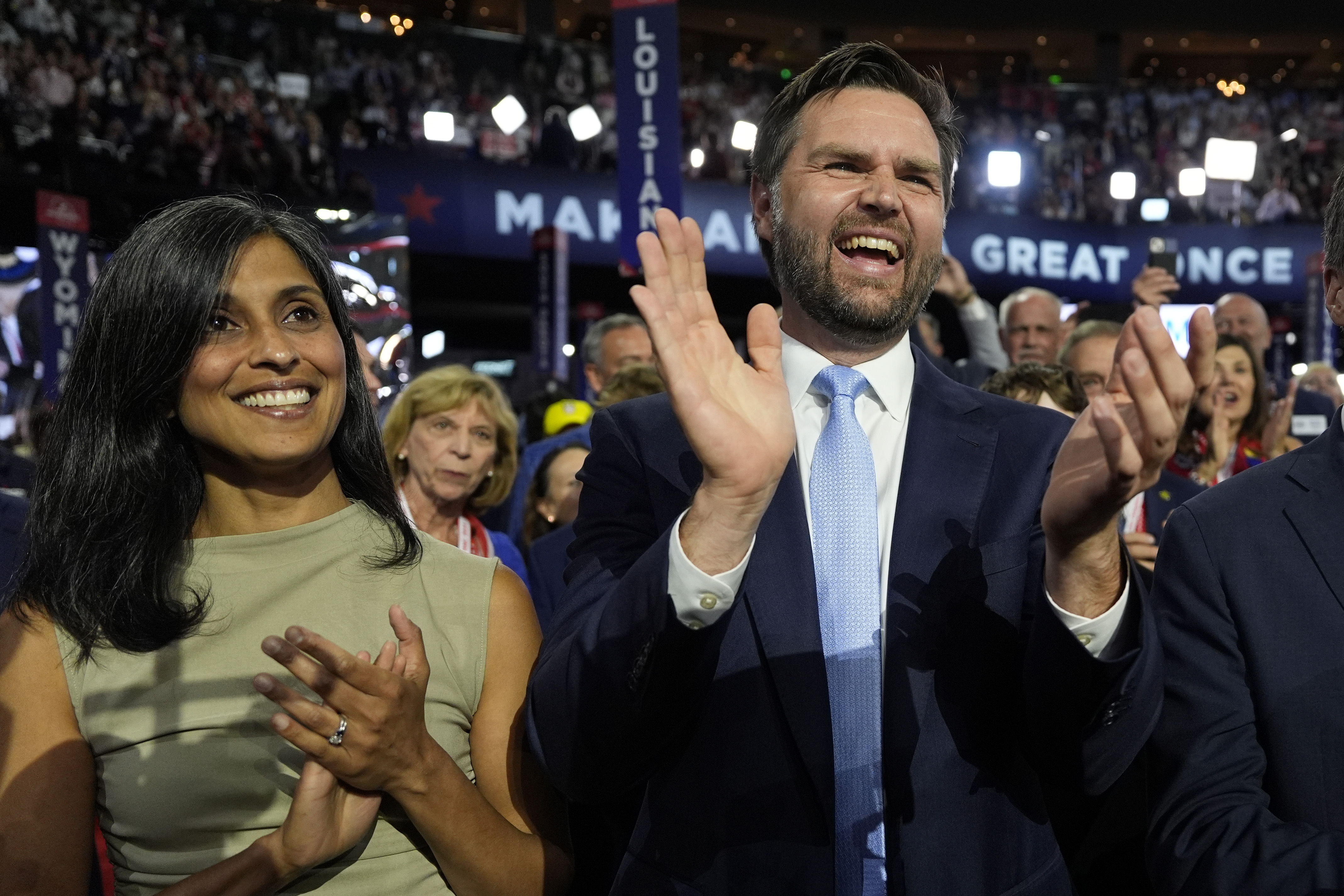 Republican vice presidential candidate Sen. JD Vance, R-Ohio, and his wife Usha Chilukuri Vance arrive on the floor during the first day of the 2024 Republican National Convention at the Fiserv Forum, Monday, July 15, 2024, in Milwaukee. (AP Photo/Carolyn Kaster)
