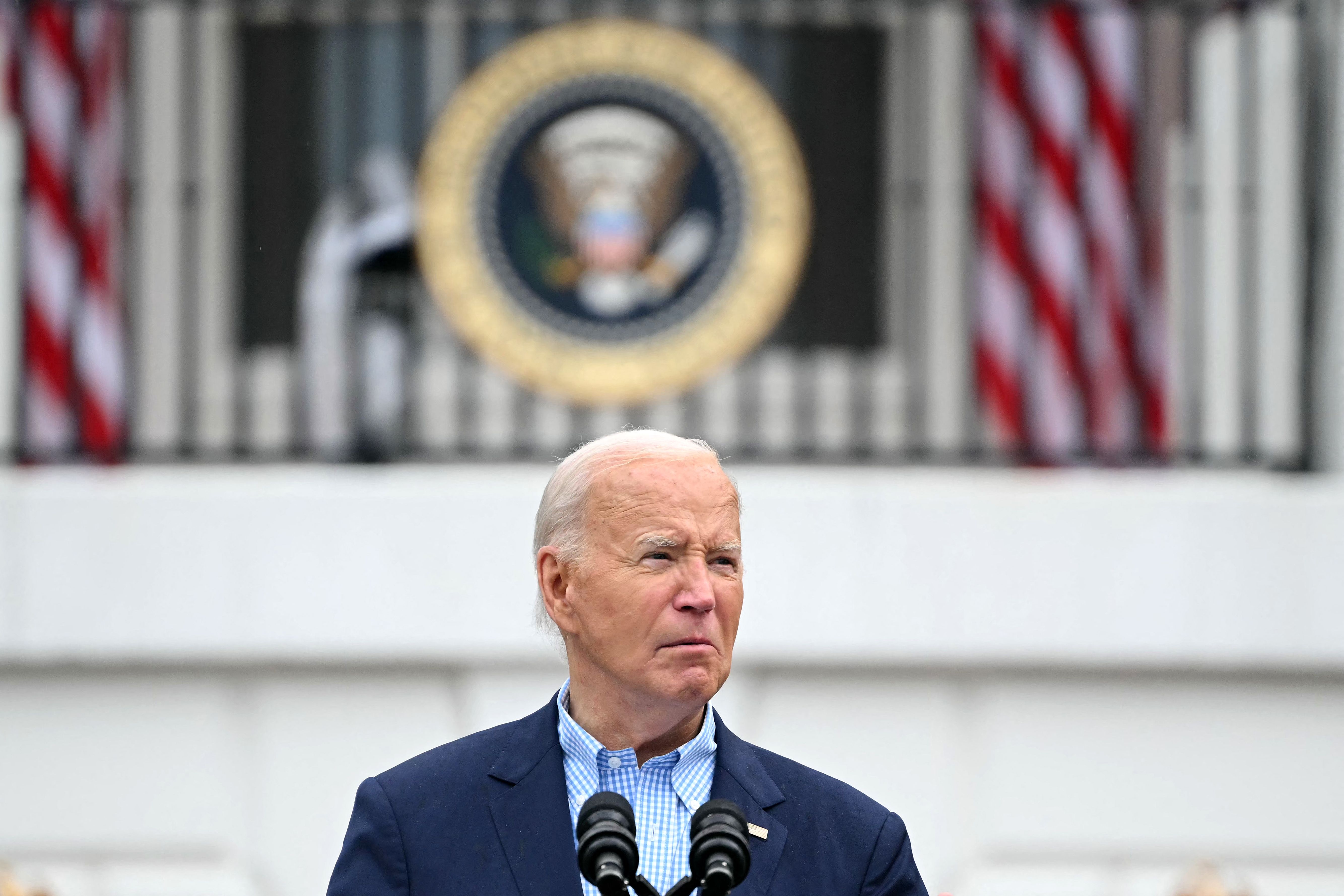 (FILES) US President Joe Biden looks on as he speaks during a barbeque for active-duty military families in honor of the Fourth of July on the South Lawn of the White House in Washington, DC, July 4, 2024. Joe Biden on July 21, 2024 dropped out of the US presidential election and endorsed Vice President Kamala Harris as the Democratic Party's new nominee, in a stunning move that upends an already extraordinary 2024 race for the White House. Biden, 81, said he was acting in the "best interest of my party and the country" by bowing to weeks of pressure after a disastrous June debate against Donald Trump stoked worries about his age and mental fitness. (Photo by Mandel NGAN / AFP)