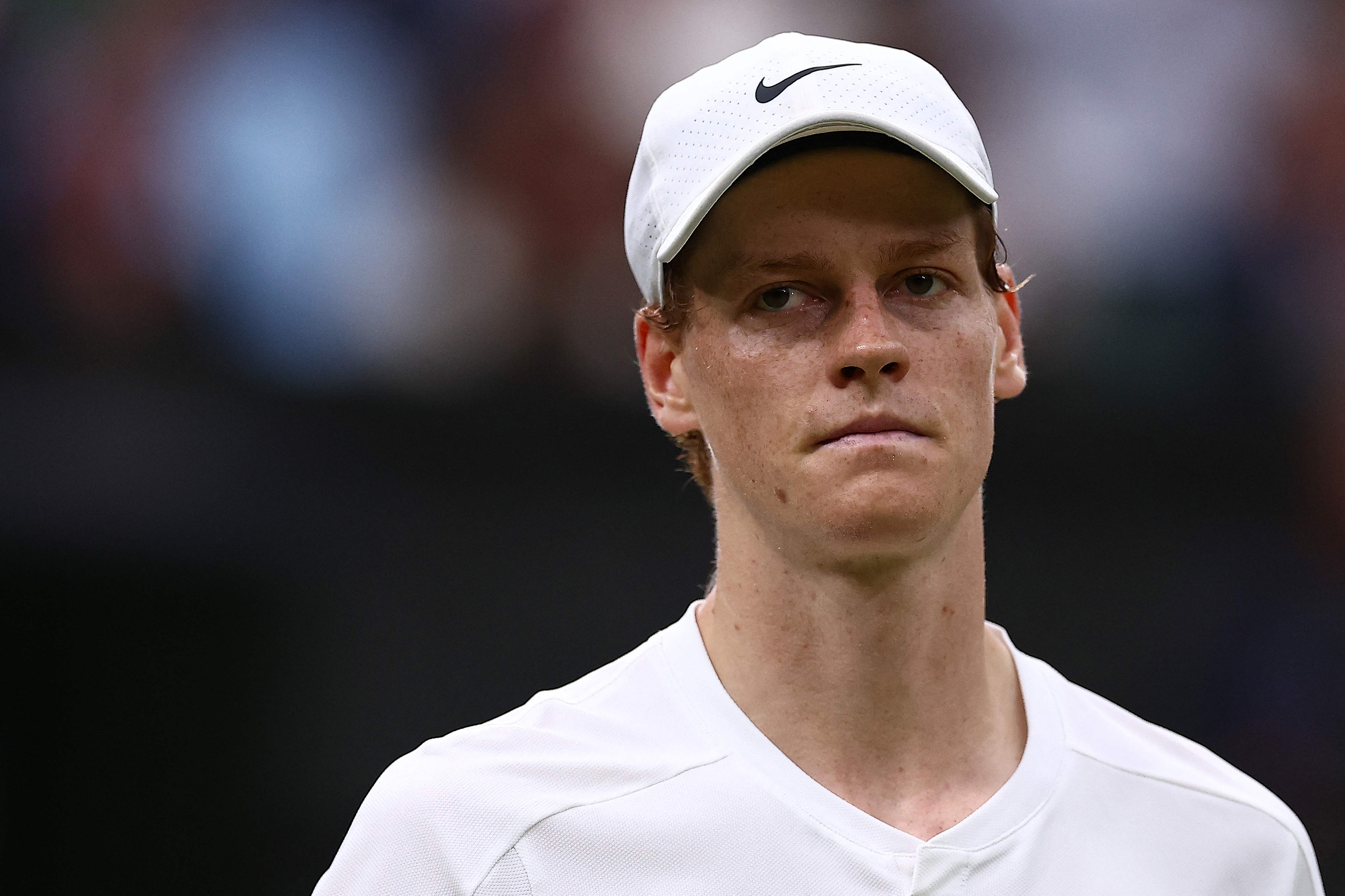 (FILES) Italy's Jannik Sinner reacts after losing against Russia's Daniil Medvedev during their men's singles quarter-final tennis match on the ninth day of the 2024 Wimbledon Championships at The All England Lawn Tennis and Croquet Club in Wimbledon, southwest London, on July 9, 2024. Jannik Sinner has pulled out of the Paris Olympics tennis tournament after being diagnosed with tonsillitis, the men's world number one confirmed on July 24, 2024. (Photo by HENRY NICHOLLS / AFP) / RESTRICTED TO EDITORIAL USE