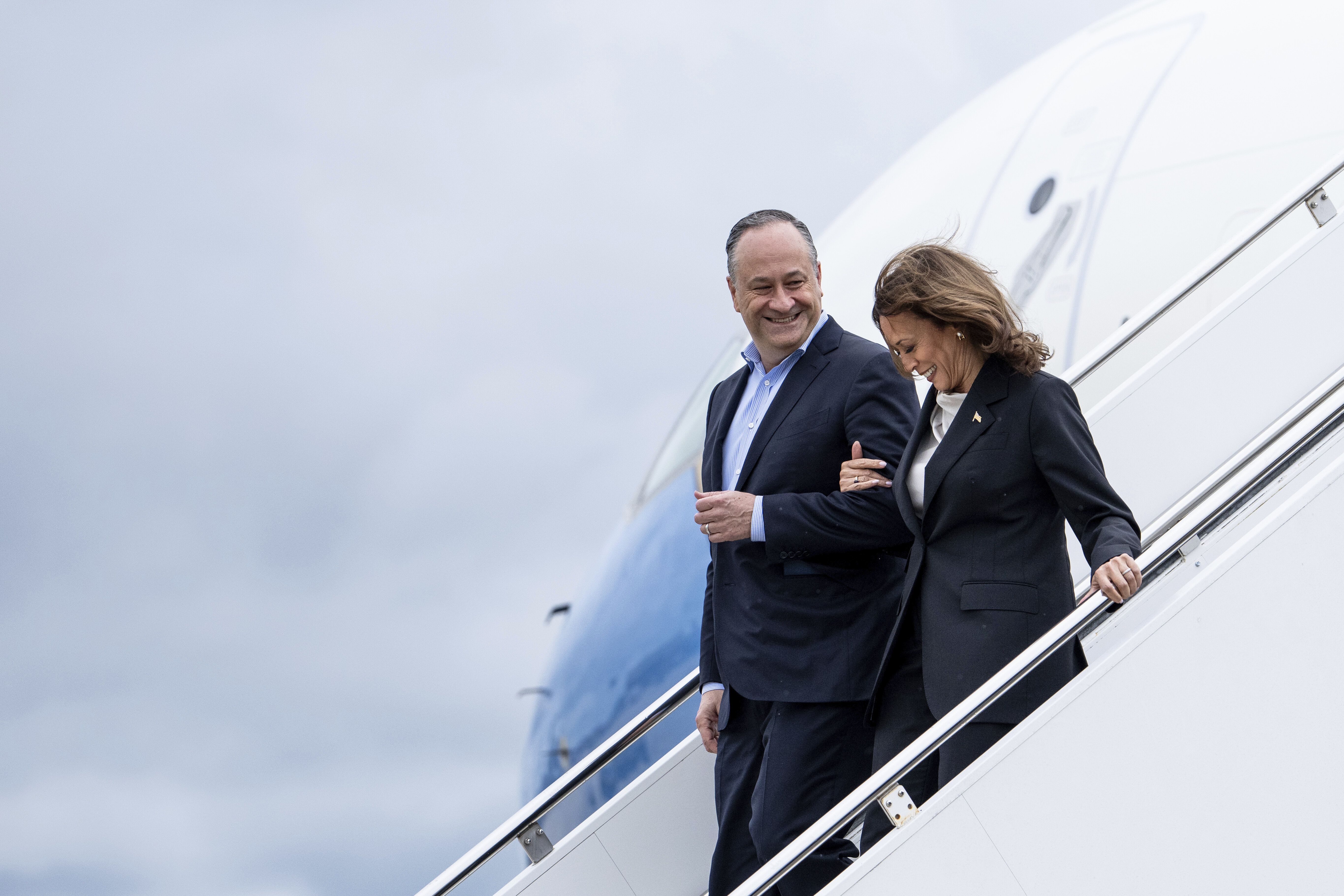 Vice President Kamala Harris, right, and second gentleman Douglas Emhoff descend from Air Force Two at Delaware Air National Guard Base in New Castle, Del., on Monday, July 22, 2024. (Erin Schaff/The New York Times via AP, Pool)