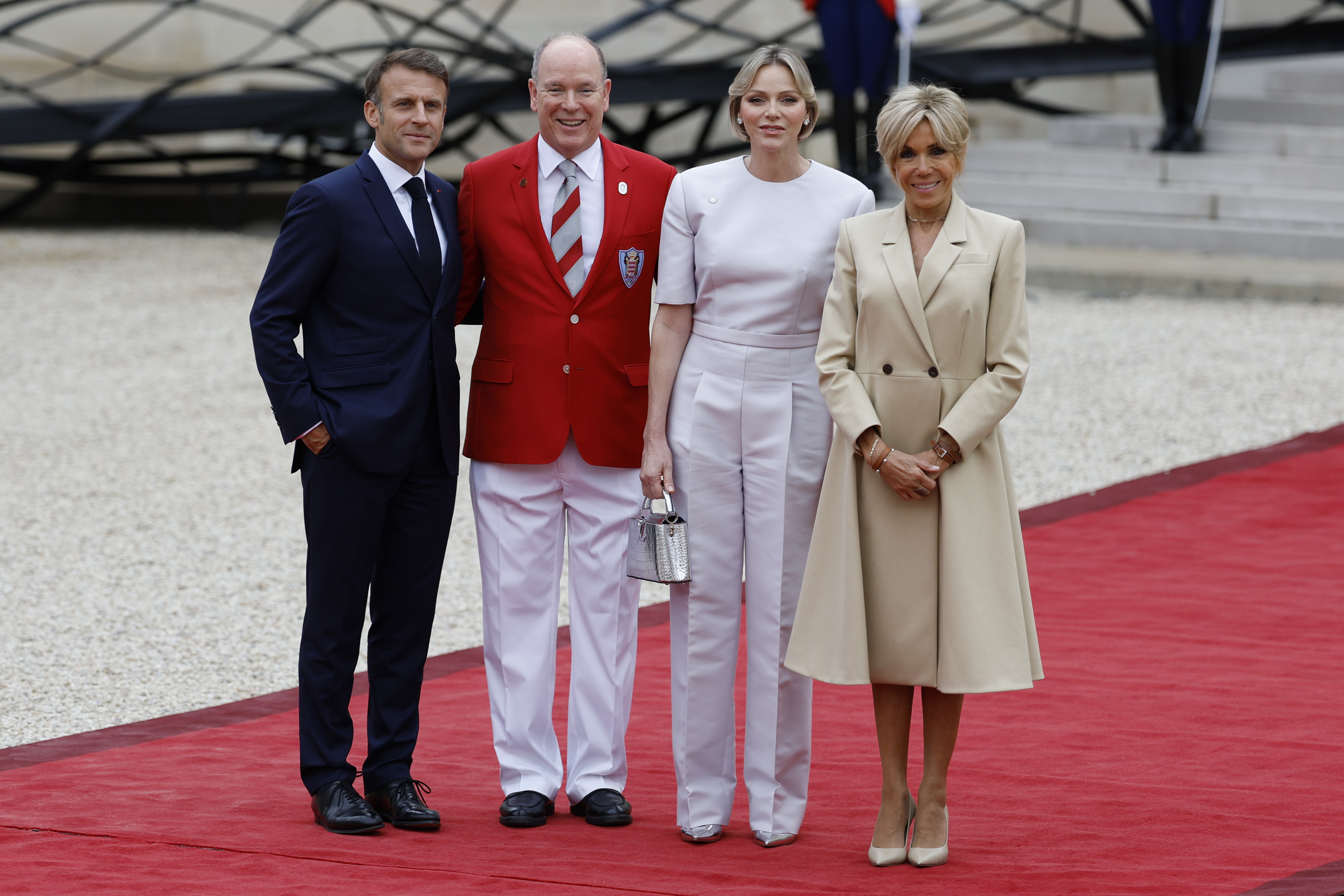 French President Emmanuel Macron and his wife Brigitte Macron, right, welcome Prince Albert II of Monaco and Princess Charlene of Monaco ahead of an opening ceremony in which 7,000 Olympic athletes are due to sail down the Seine past iconic Parisian monuments, at the 2024 Summer Olympics, Friday, July 26, 2024, at the Elysee Palace in Paris, France. (AP Photo/Aurelien Morissard)